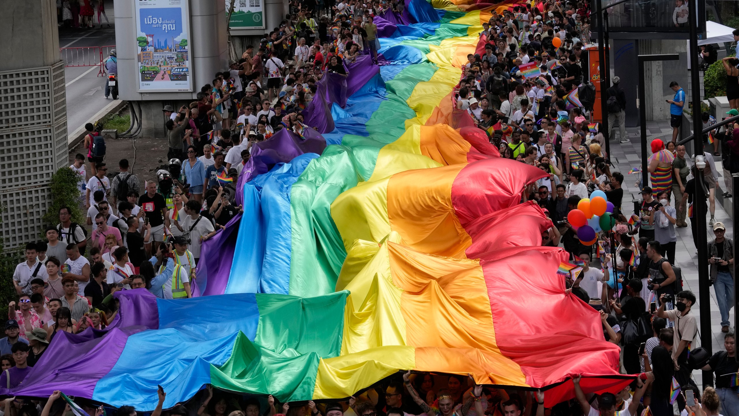 FILE - Participants hold a rainbow flag during the Pride Parade in Bangkok, Thailand, Saturday, June 1, 2024. (AP Photo/Sakchai Lalit, file)