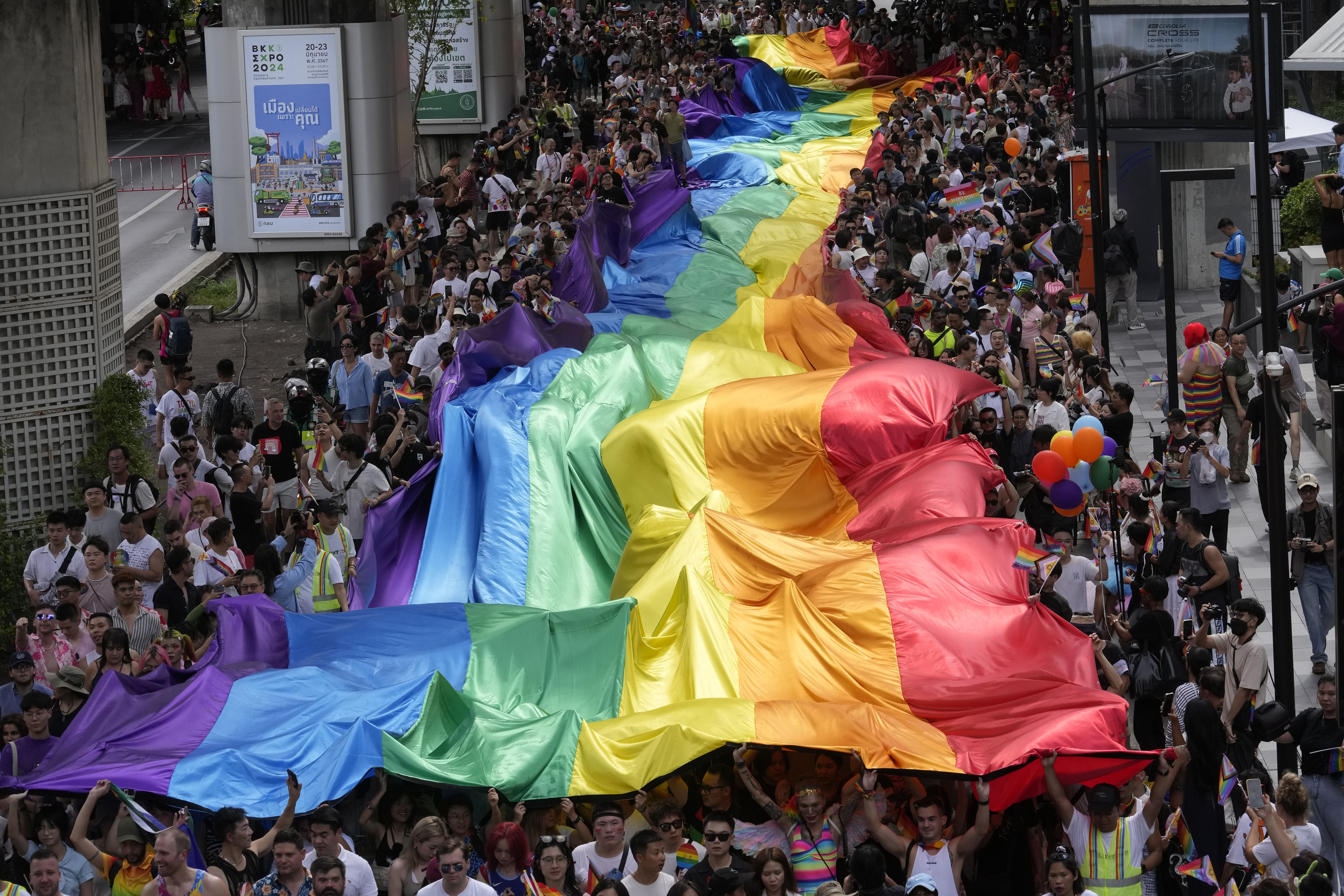 FILE - Participants hold a rainbow flag during the Pride Parade in Bangkok, Thailand, Saturday, June 1, 2024. (AP Photo/Sakchai Lalit, file)