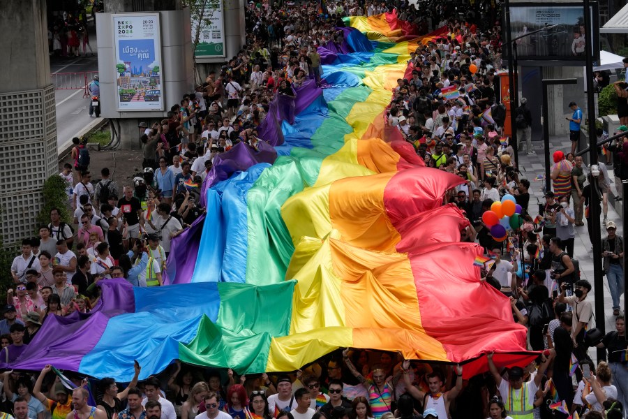 FILE - Participants hold a rainbow flag during the Pride Parade in Bangkok, Thailand, Saturday, June 1, 2024. (AP Photo/Sakchai Lalit, file)
