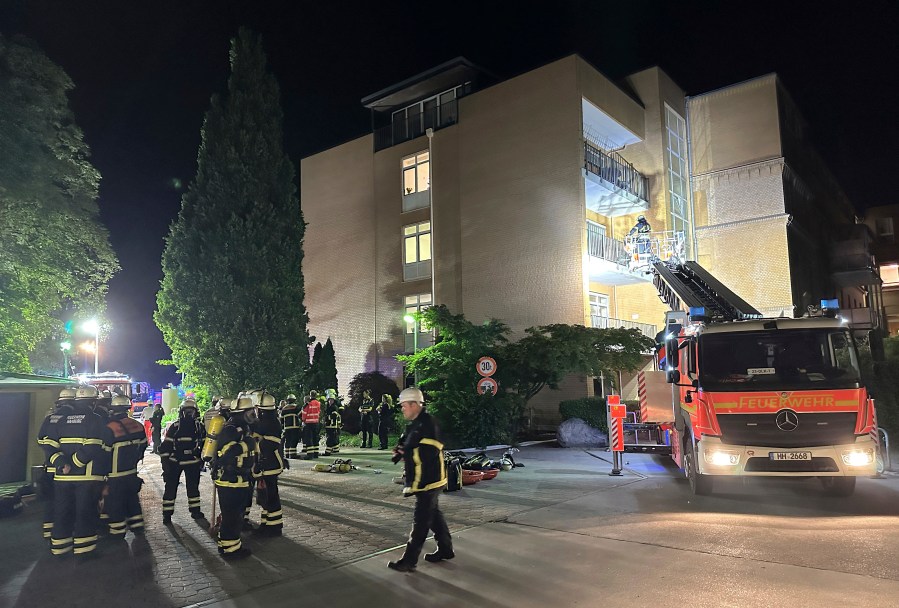 Firefighters with breathing apparatus and a ladder truck work at the Marienkrankenhaus hospital in Hamburg's Hohenfelde district of Hamburg, Germany Sunday, June 1, 2025. (Steven Hutchings/dpa via AP)