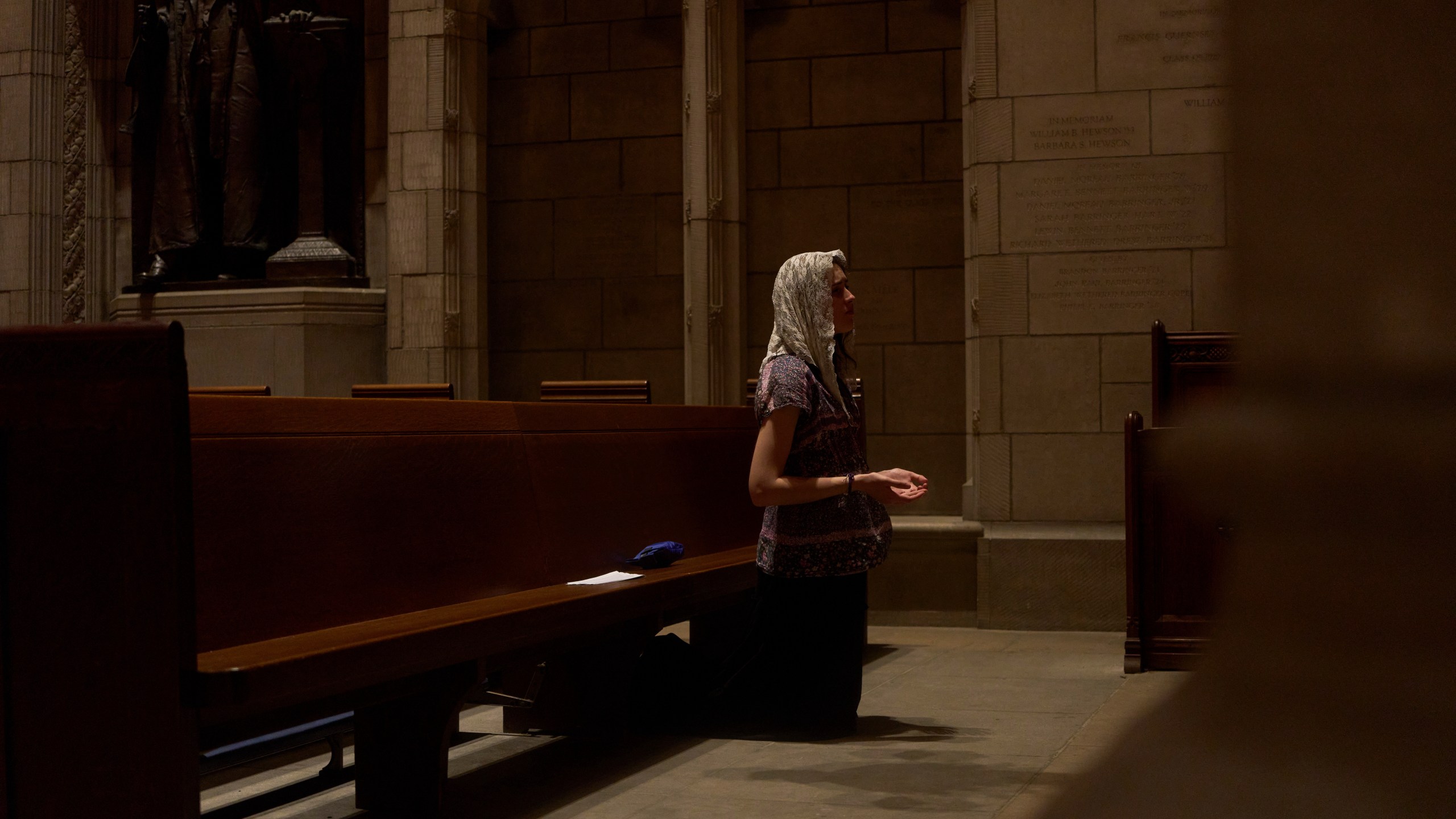 Savannah Nichols, visiting her boyfriend, altar server David Kim, from Ohio, prays after a service at the Princeton University chapel in Princeton, N.J., on Friday, May 16, 2025. (AP Photo/Luis Andres Henao)