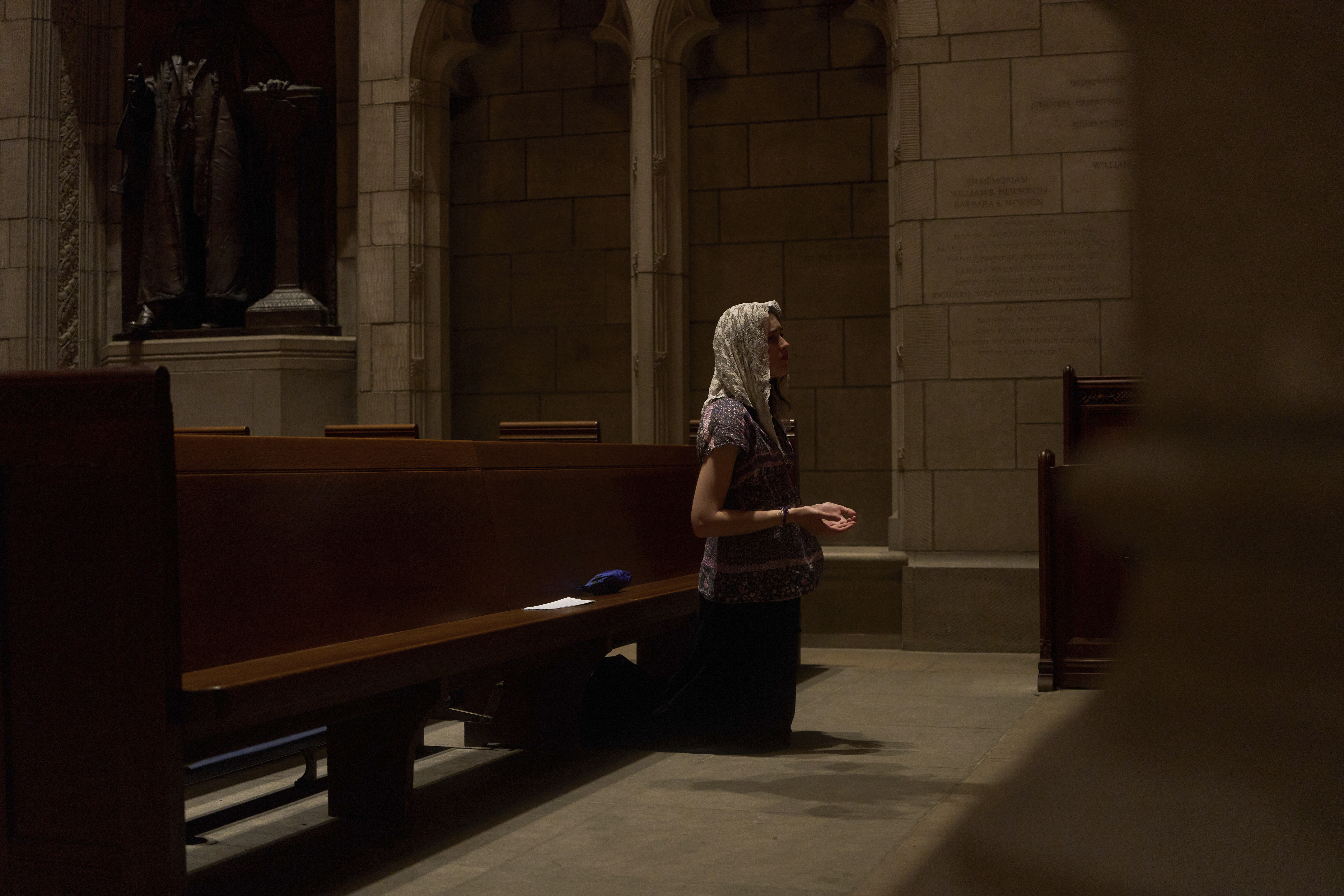 Savannah Nichols, visiting her boyfriend, altar server David Kim, from Ohio, prays after a service at the Princeton University chapel in Princeton, N.J., on Friday, May 16, 2025. (AP Photo/Luis Andres Henao)