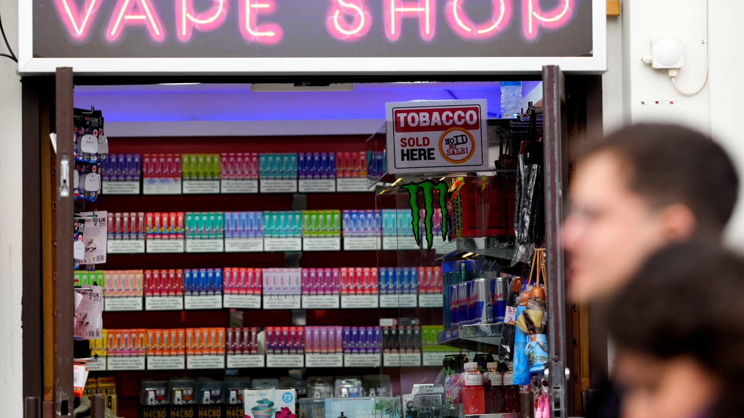 FILE - Pedestrians pass a vape shop in London, Monday, Jan. 29, 2024. (AP Photo/Kirsty Wigglesworth, File)
