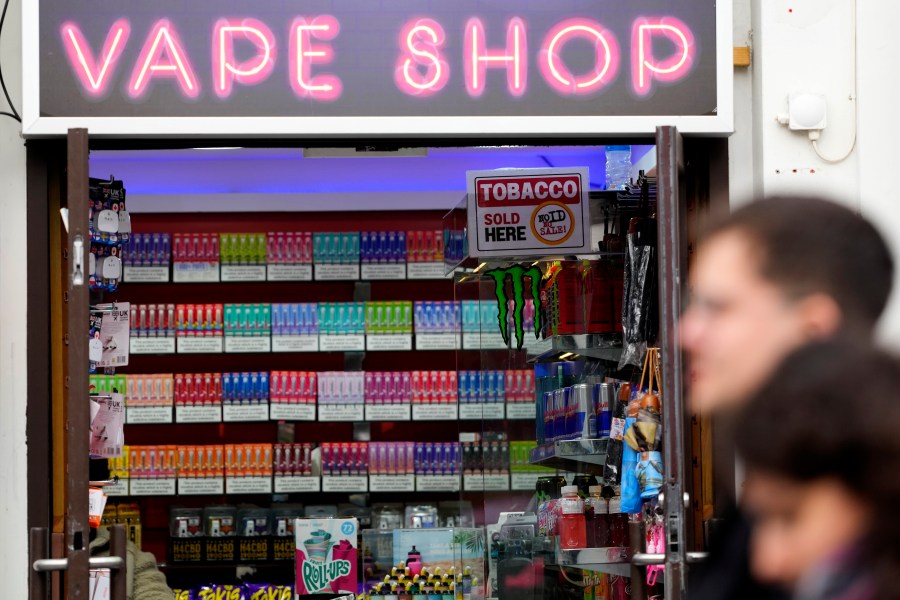 FILE - Pedestrians pass a vape shop in London, Monday, Jan. 29, 2024. (AP Photo/Kirsty Wigglesworth, File)