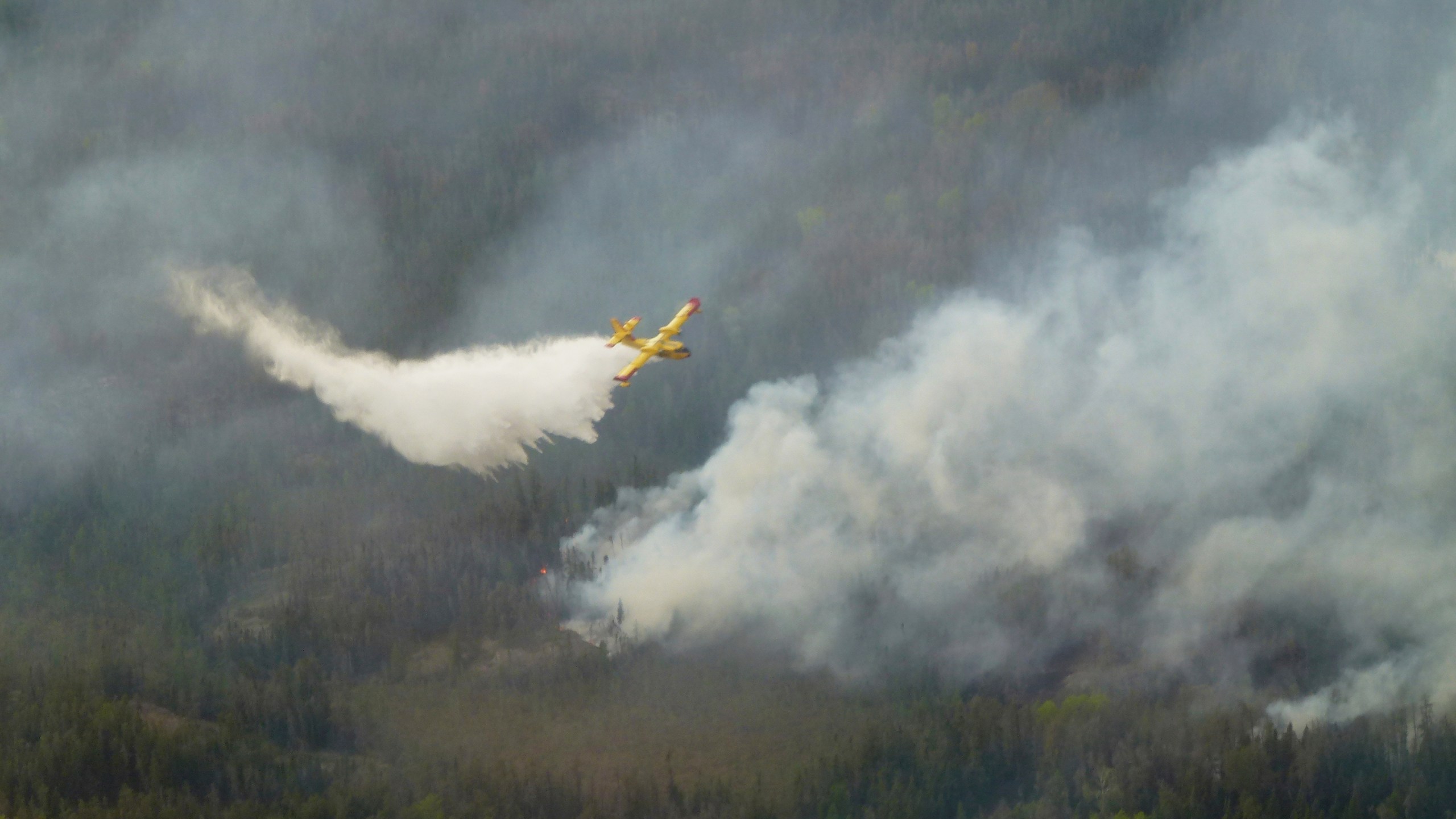 A water bomber aircraft battles a wildfire in southeast Manitoba as shown in this handout photo provided by the Manitoba government on Tuesday, May 27, 2025. (Manitoba government via The Canadian Press via AP)