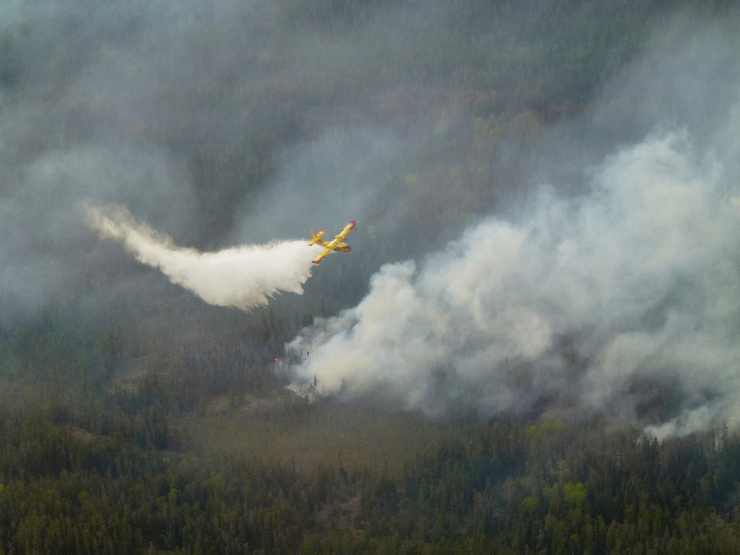 A water bomber aircraft battles a wildfire in southeast Manitoba as shown in this handout photo provided by the Manitoba government on Tuesday, May 27, 2025. (Manitoba government via The Canadian Press via AP)