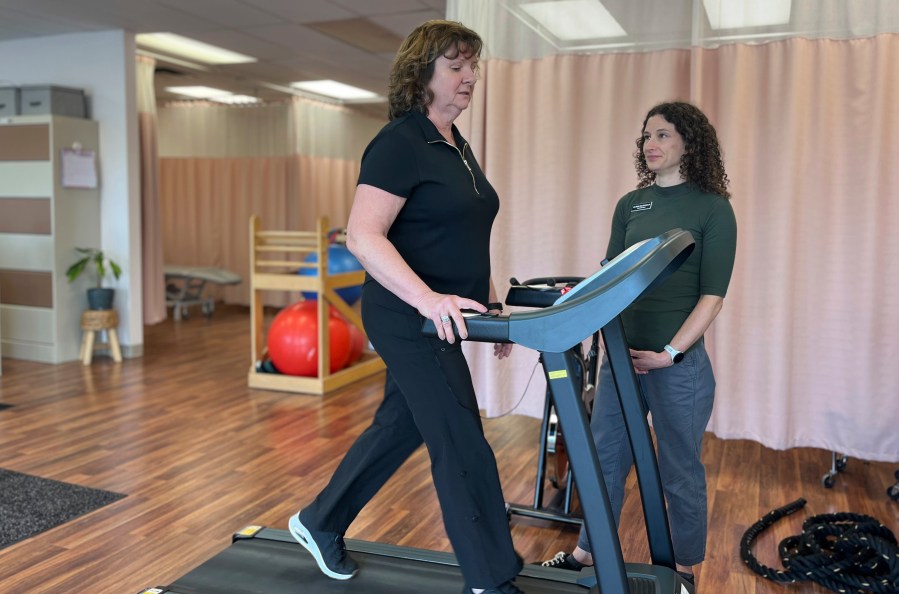 Terri Swain-Collins uses a treadmill in the care of physiotherapist Alison MacDonald on May 20, 2025, at Kingston Injury Management, a clinic in Kingston, Ontario, in Canada. (Lisa Callahan via AP)