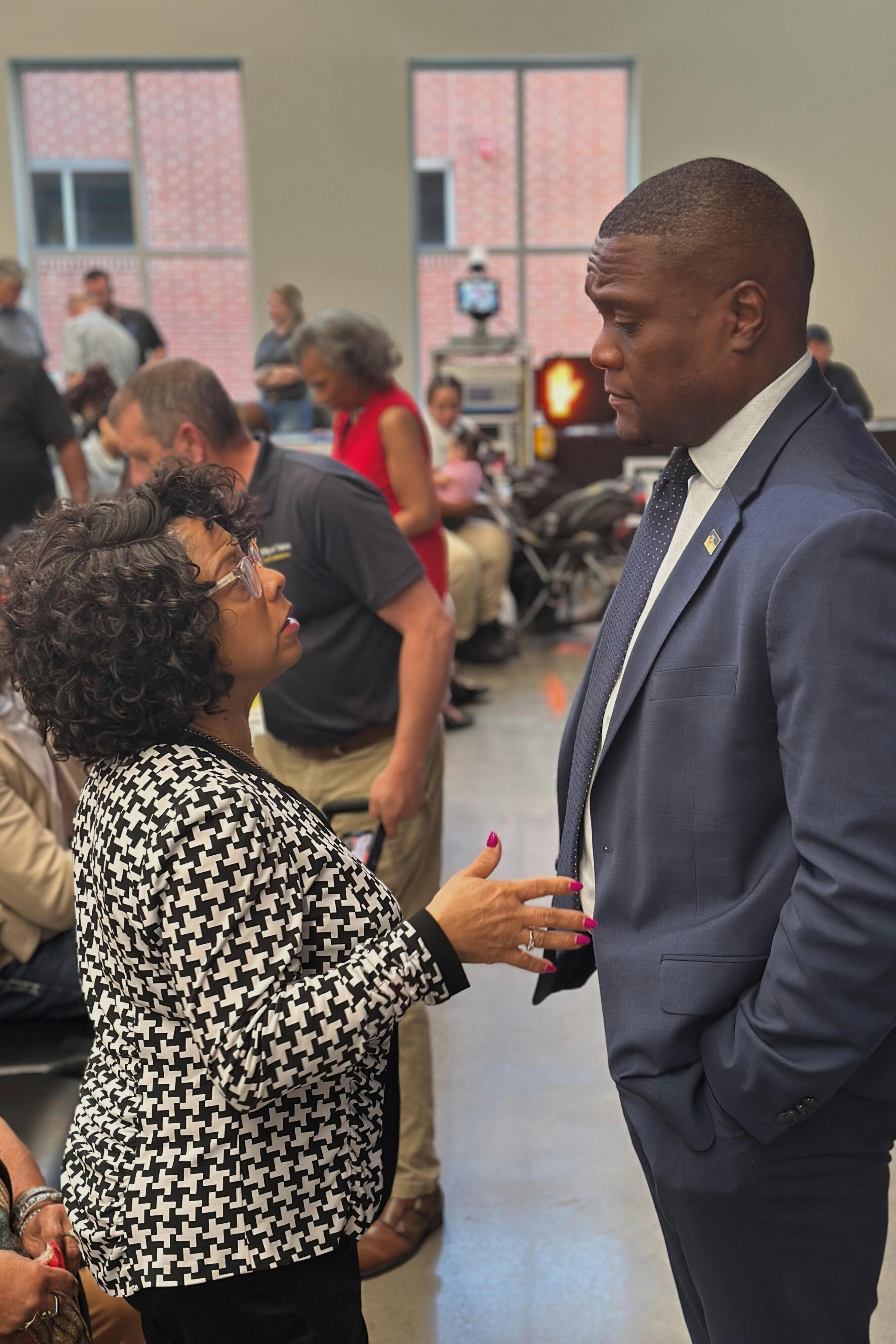 Tulsa Mayor Monroe Nichols speaks to North Tulsa resident Jacqueline Weary, a descendant of a Tulsa Race Massacre survivor, on Thursday, May 22, 2025. (AP Photo/Sean Murphy