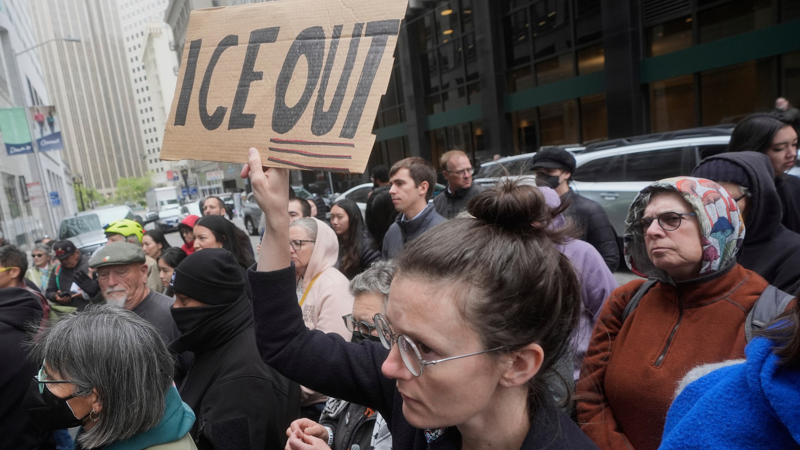 FILE - A person holds up a sign during a news conference and rally by immigrant justice organizations and advocates protesting ICE arrests in San Francisco, Wednesday, May 28, 2025. (AP Photo/Jeff Chiu, File)
