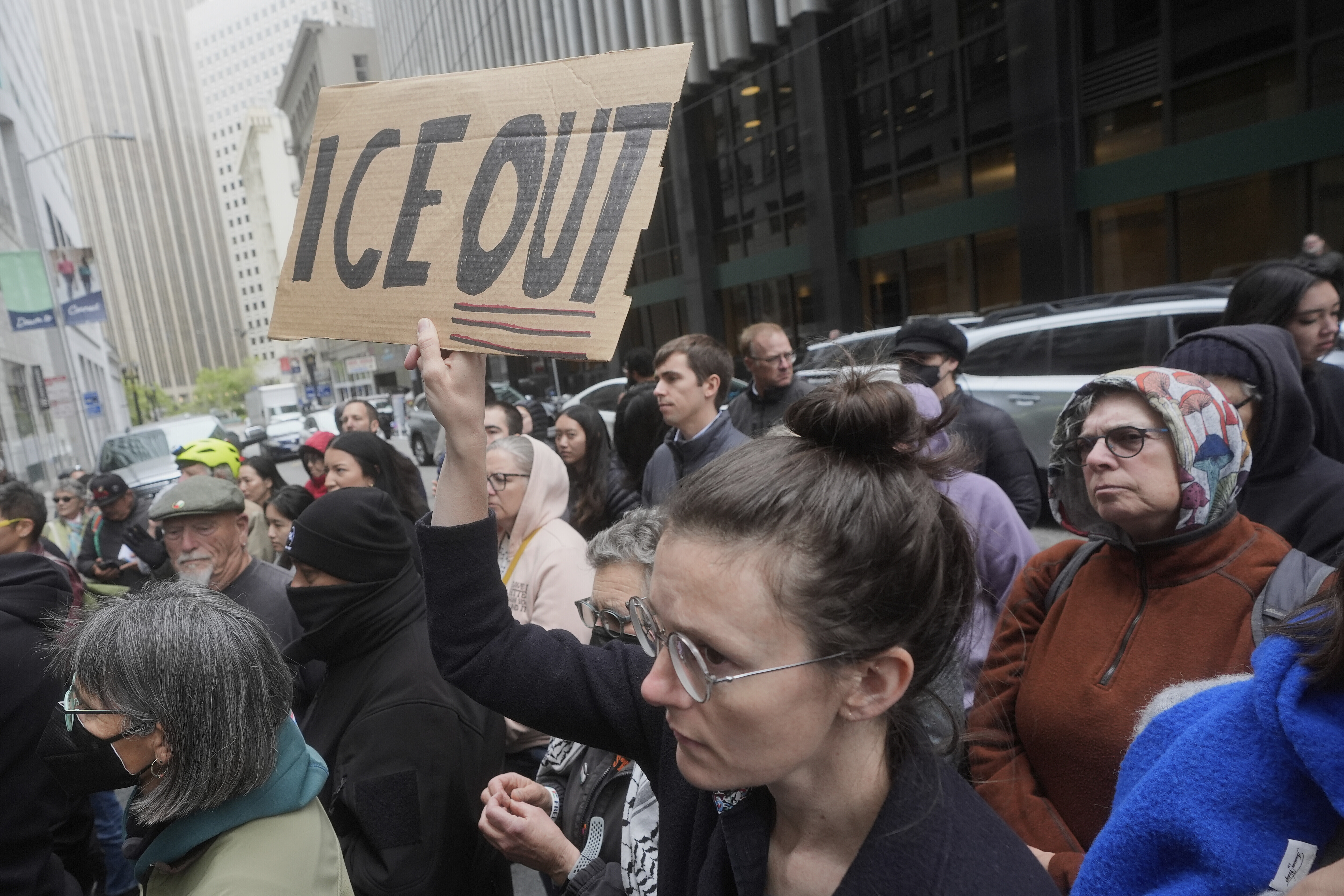 FILE - A person holds up a sign during a news conference and rally by immigrant justice organizations and advocates protesting ICE arrests in San Francisco, Wednesday, May 28, 2025. (AP Photo/Jeff Chiu, File)