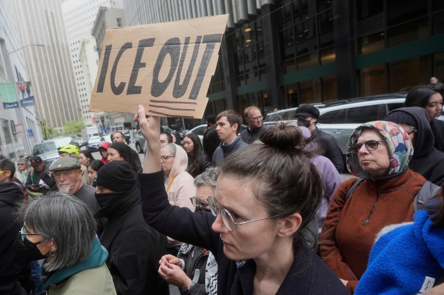 FILE - A person holds up a sign during a news conference and rally by immigrant justice organizations and advocates protesting ICE arrests in San Francisco, Wednesday, May 28, 2025. (AP Photo/Jeff Chiu, File)