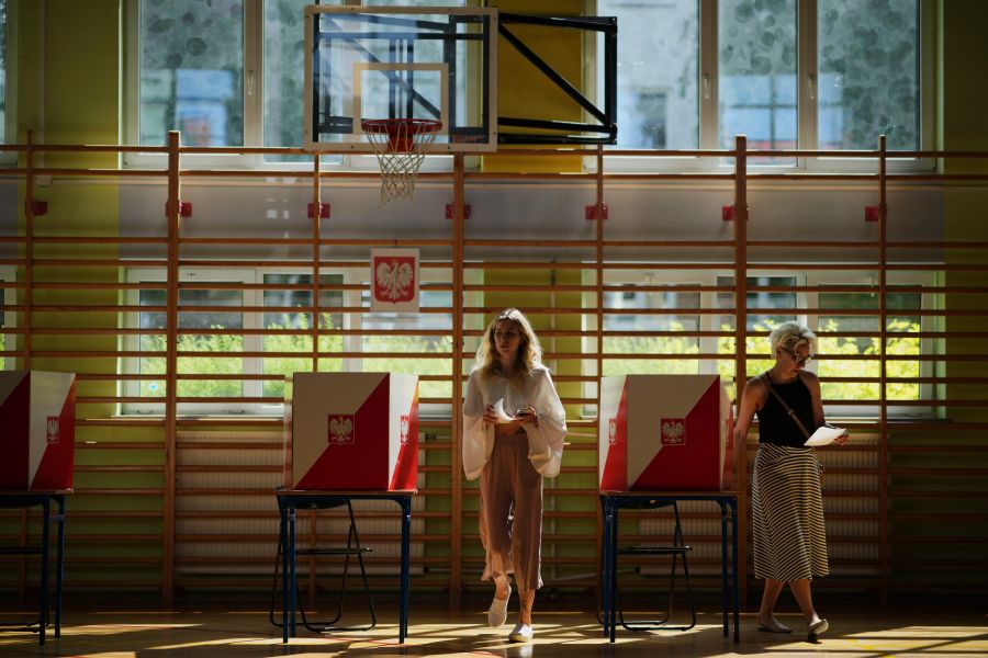 A woman prepares to cast her vote during the presidential election runoff in Warsaw, Poland, Sunday, June 1, 2025. (AP Photo/Petr David Josek)