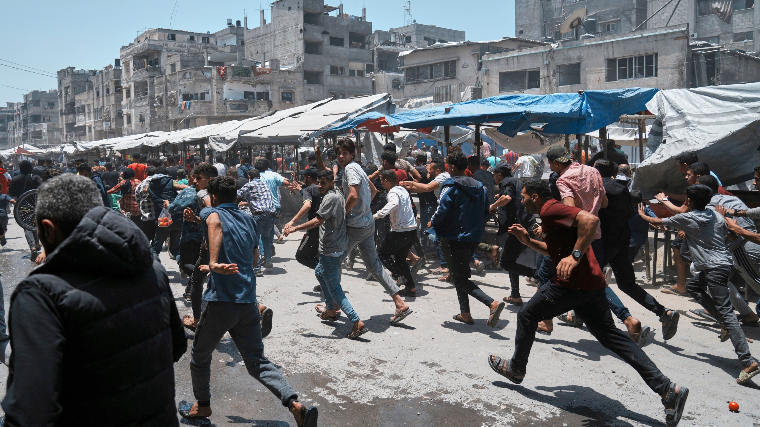 Palestinians run following an Israeli strike in Gaza City, Sunday, June 1, 2025. (AP Photo/Jehad Alshrafi)
