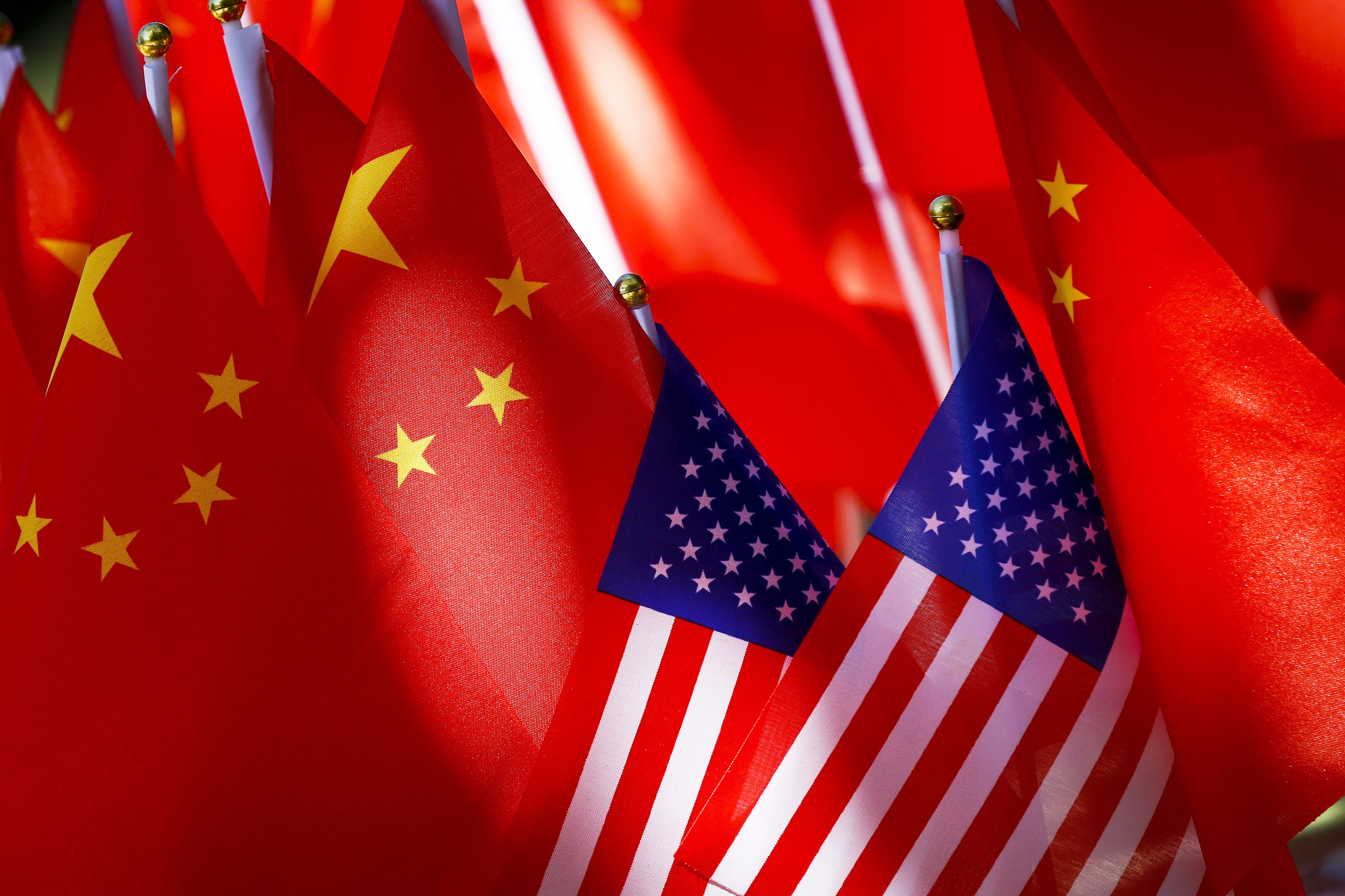 FILE - American flags are displayed together with Chinese flags on top of a trishaw on Sept. 16, 2018, in Beijing. (AP Photo/Andy Wong, File)