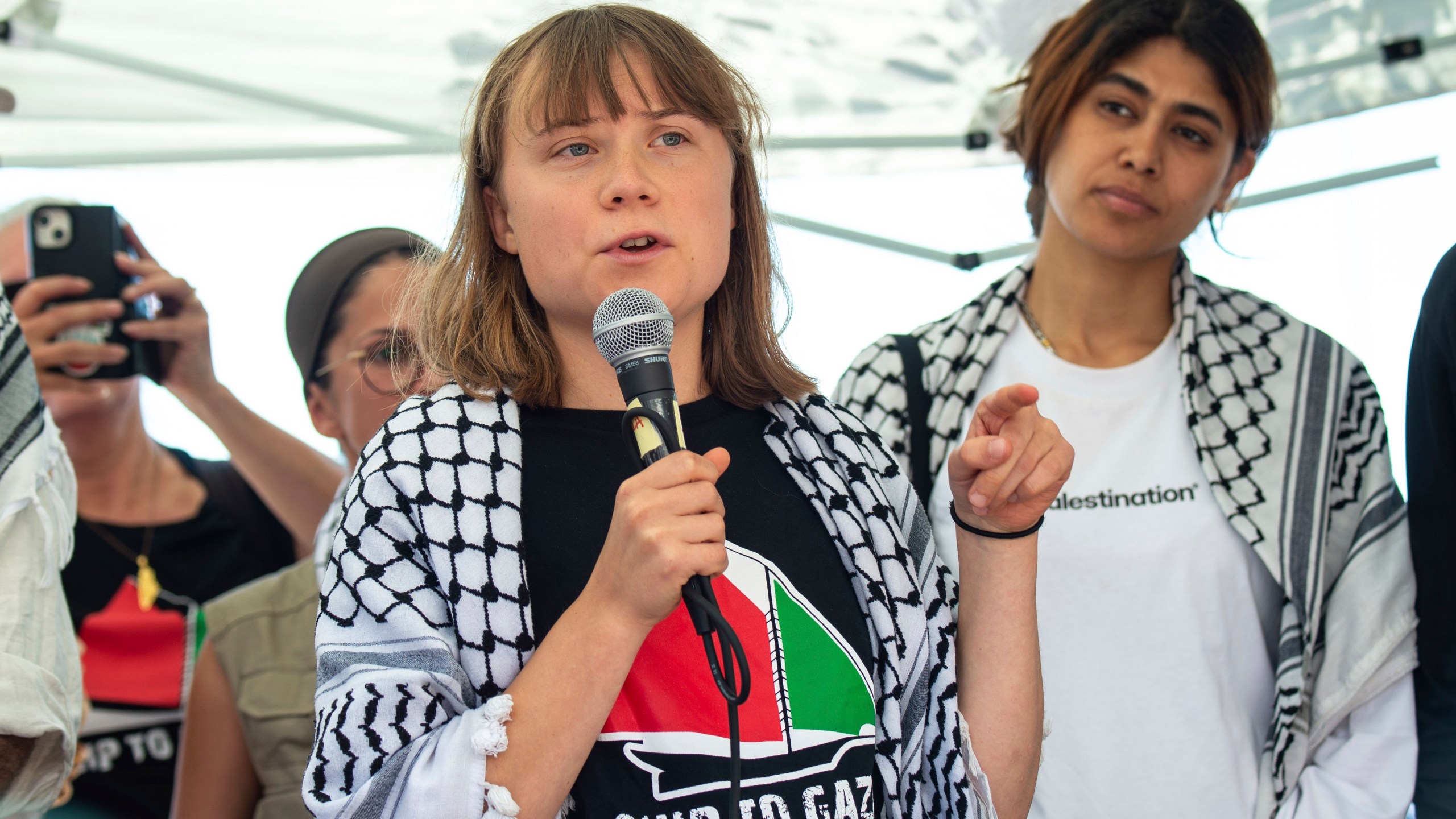 Climate activist Greta Thunberg with other activists from a human rights organization meets with journalists in Catania, Italy, Sunday, June 1, 2025, ahead of their departure for the Mideast. (AP Photo/Salvatore Cavalli)