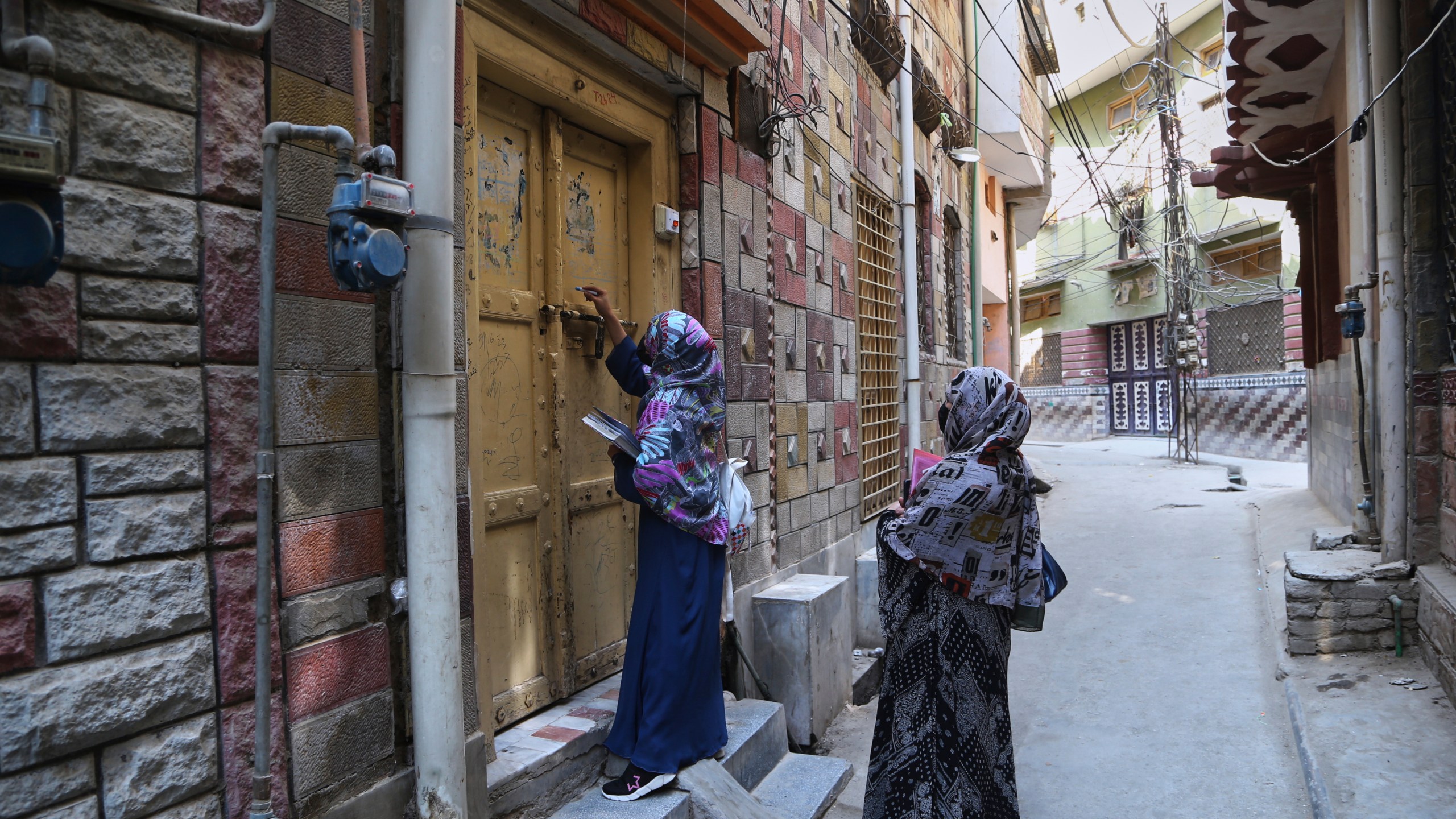 A health worker marks a house after administrating a polio vaccine to a child at a neighborhood in Peshawar, Pakistan, Monday, May 26, 2025. (AP Photo/Muhammad Sajjad)
