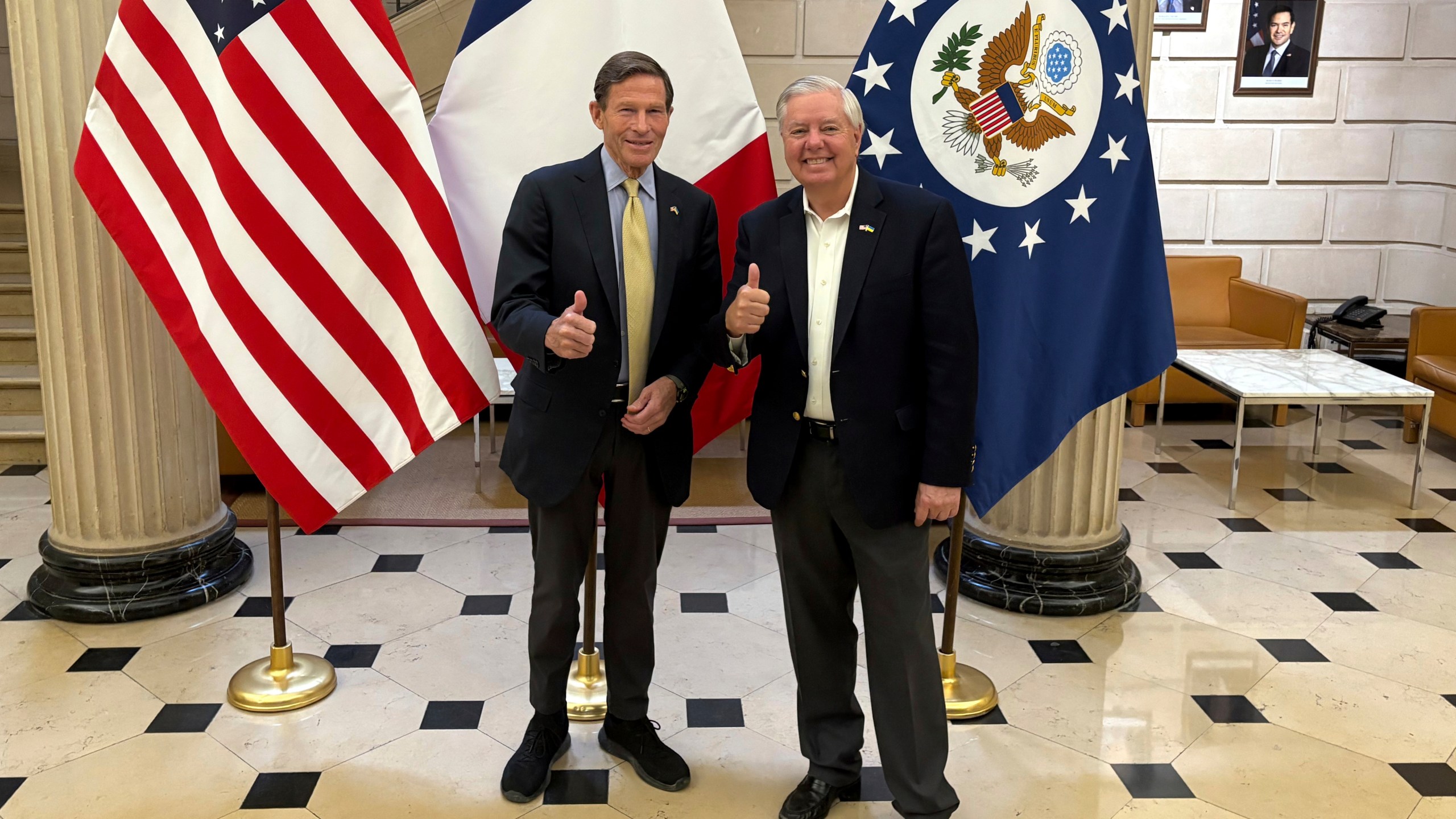 Sen. Richard Blumenthal, D-Conn., left, and Sen. Lindsey Graham, R-S.C thumb up during a news event at the US embassy to France, Sunday, June 1, 2025 in Paris. (AP Photo/Thomas Adamson)