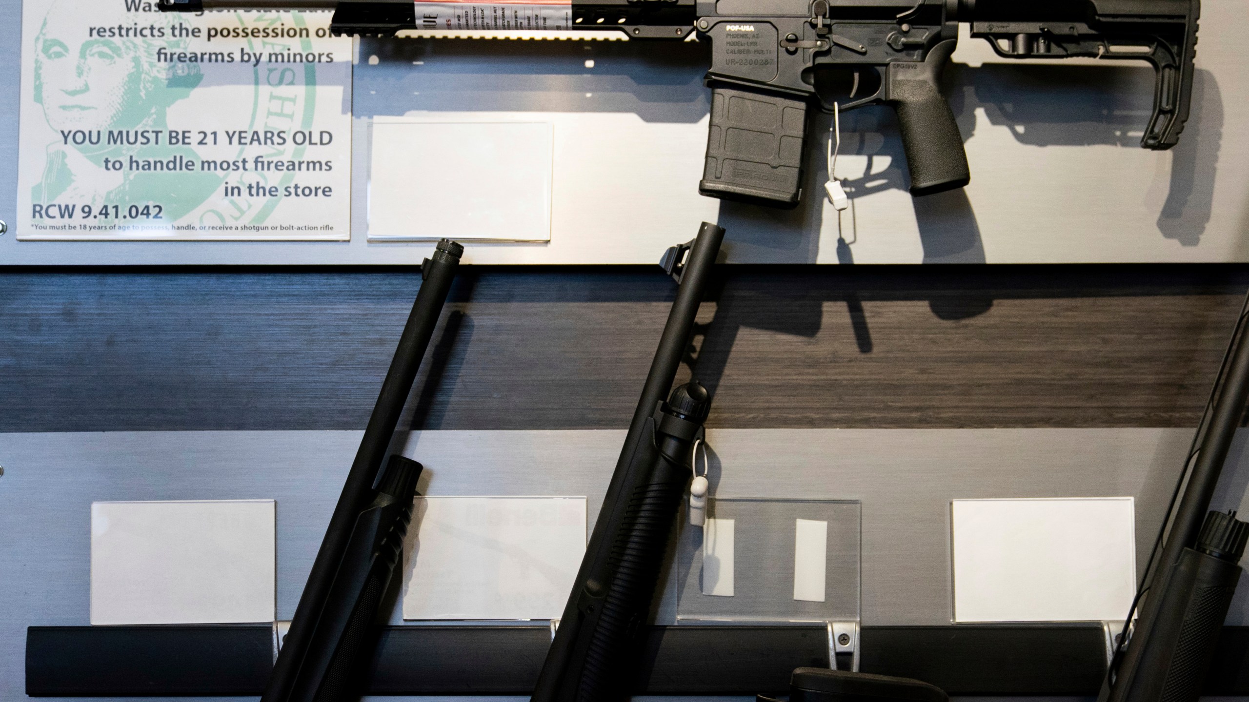 FILE - A semi-automatic rifle is displayed above shotguns at Rainier Arms, April 14, 2023, in Auburn, Wash. (AP Photo/Lindsey Wasson, File)