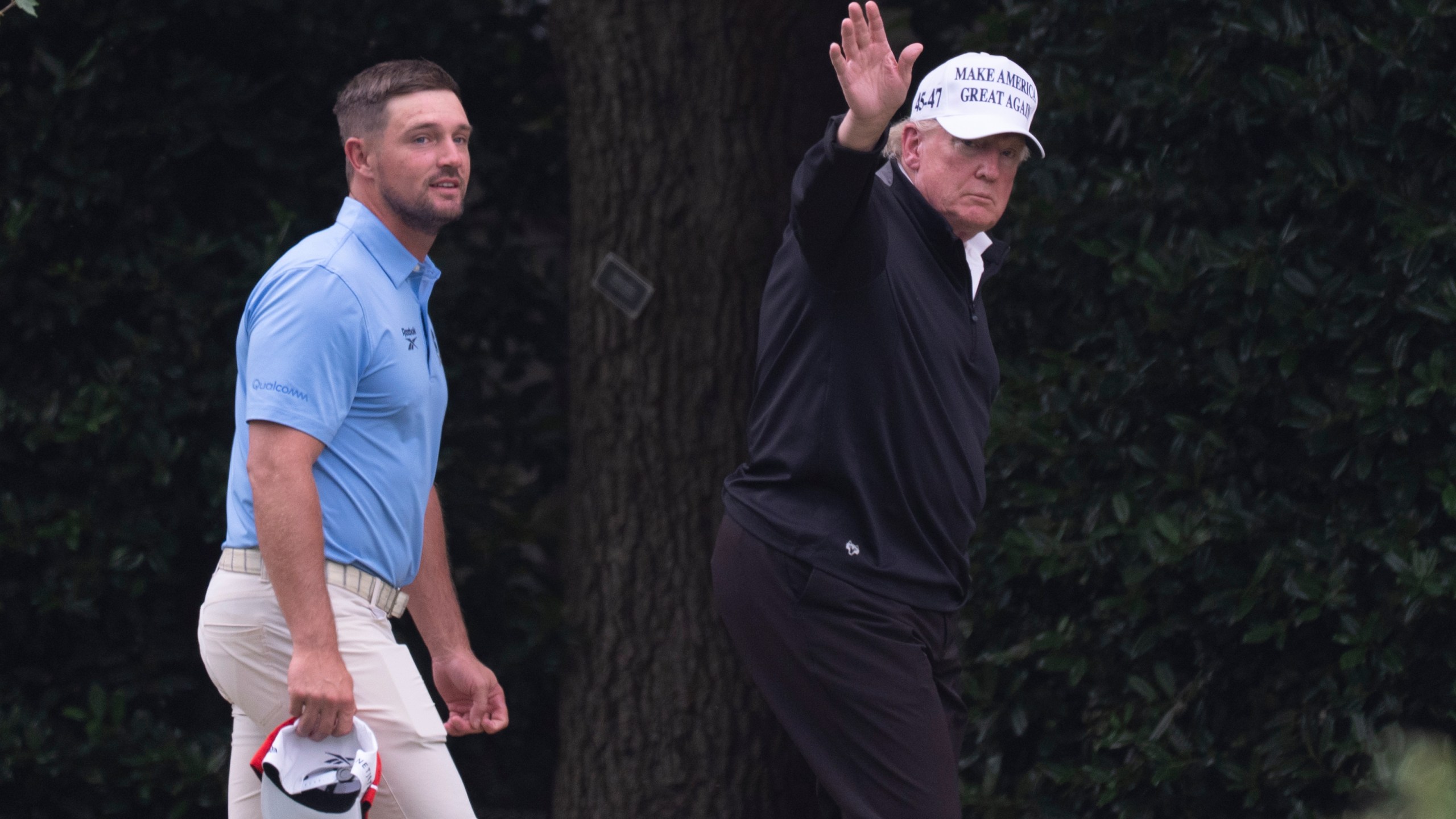 President Donald Trump, right, walks toward the Oval Office as he returns to the White House with Bryson DeChambeau, winner of the 2024 U.S. Open, after playing golf, Sunday, June 1, 2025. (AP Photo/Manuel Balce Ceneta)