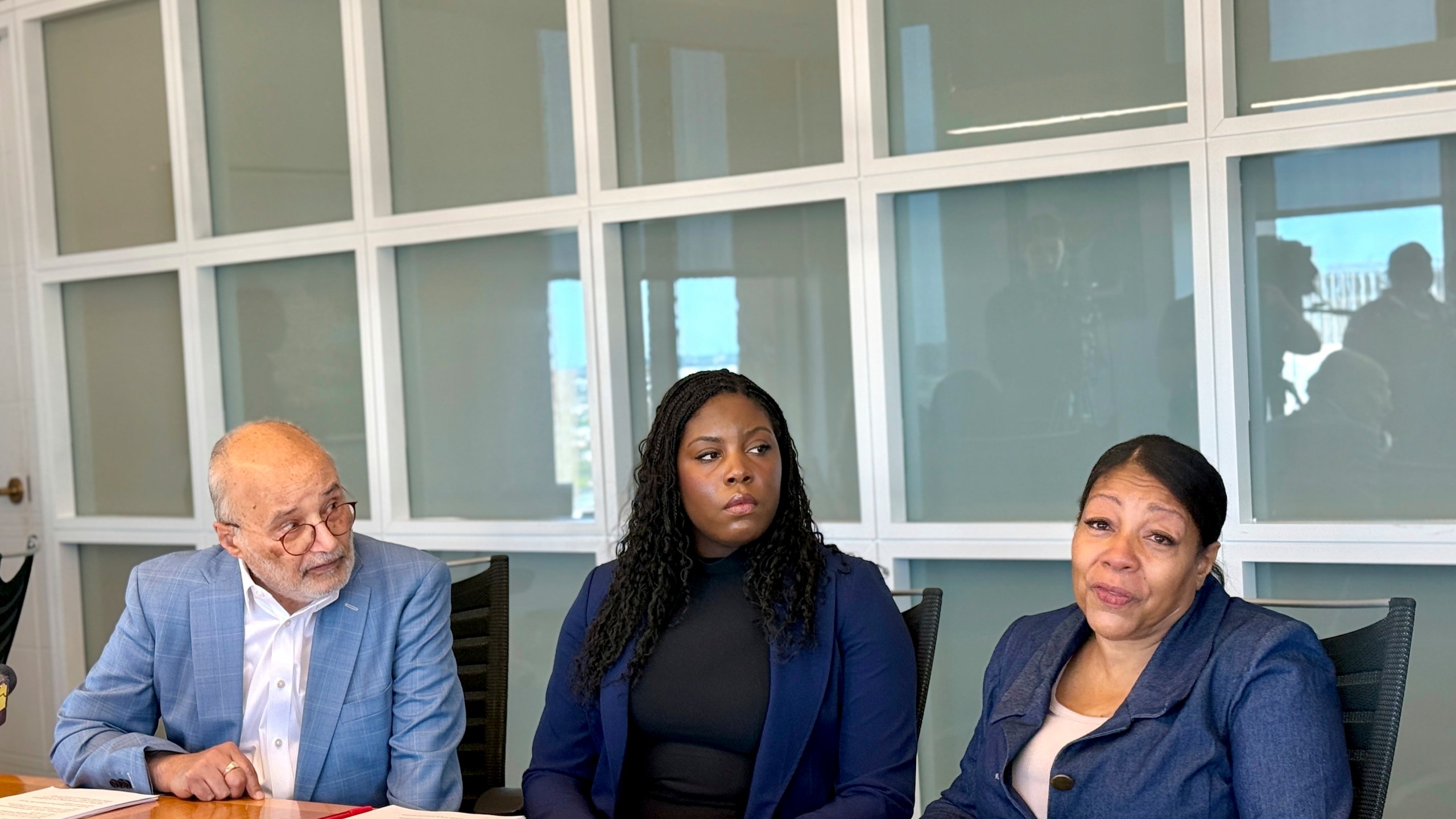 Attorneys Billy Murphy, left, and Janai Woodhouse look on as Collette Lee speaks about how a Baltimore special education teacher sexually abused her decades ago during a news conference Monday, June 2, 2025 at the offices of Murphy, Falcon Murphy in downtown Baltimore. (AP Photo/Lea Skene)
