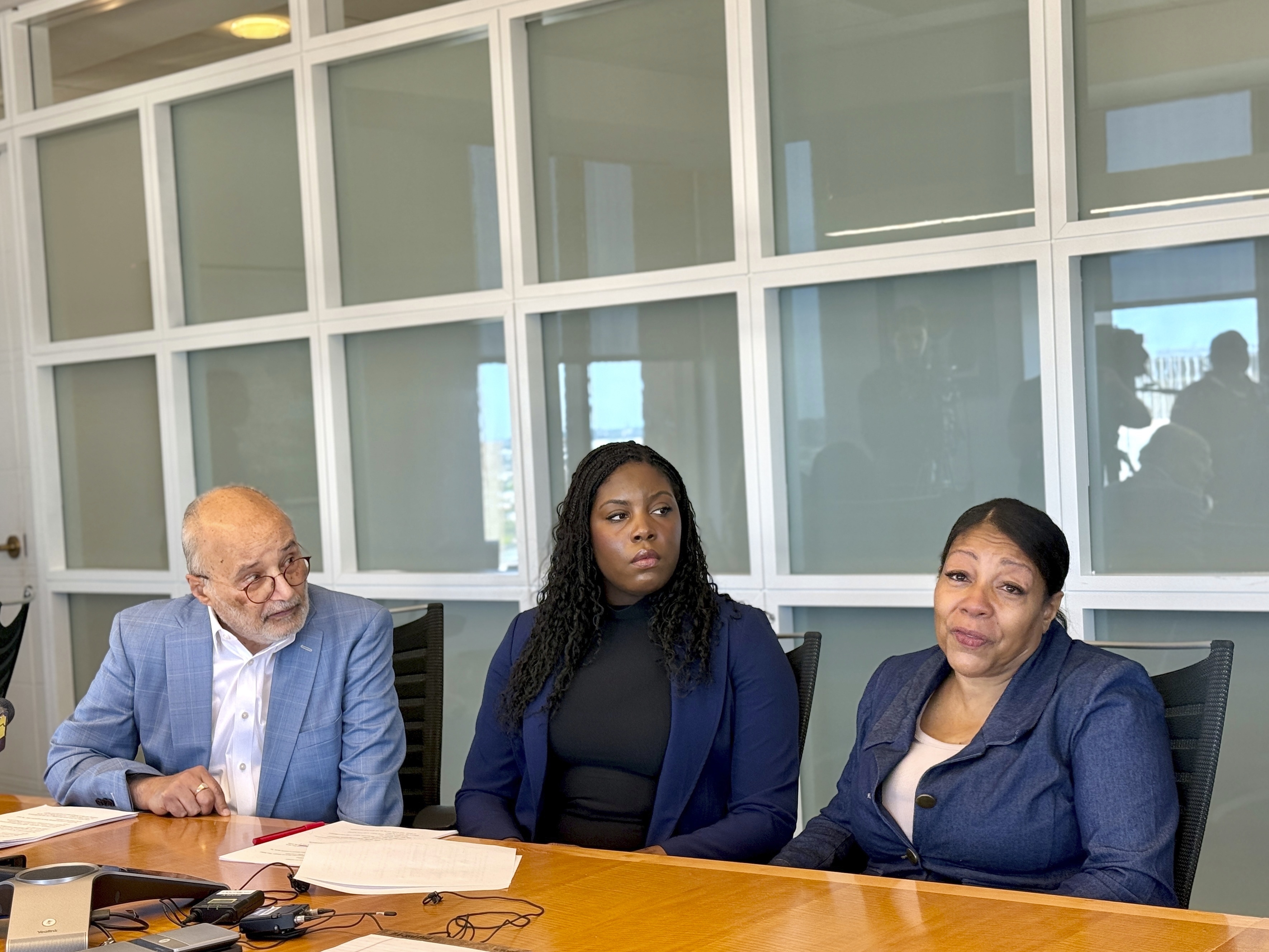Attorneys Billy Murphy, left, and Janai Woodhouse look on as Collette Lee speaks about how a Baltimore special education teacher sexually abused her decades ago during a news conference Monday, June 2, 2025 at the offices of Murphy, Falcon Murphy in downtown Baltimore. (AP Photo/Lea Skene)