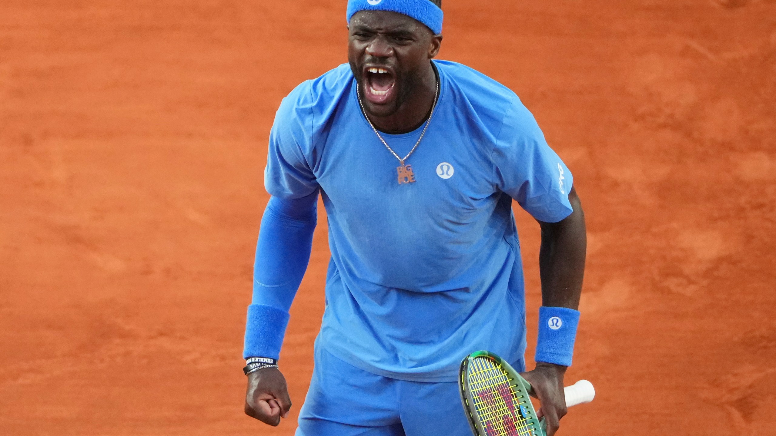 Frances Tiafoe of the U.S. celebrates beating Germany's Daniel Altmaier during their fourth round match of the French Tennis Open, at the Roland-Garros stadium, in Paris, Sunday, June 1 2025. (AP Photo/Lindsey Wasson)