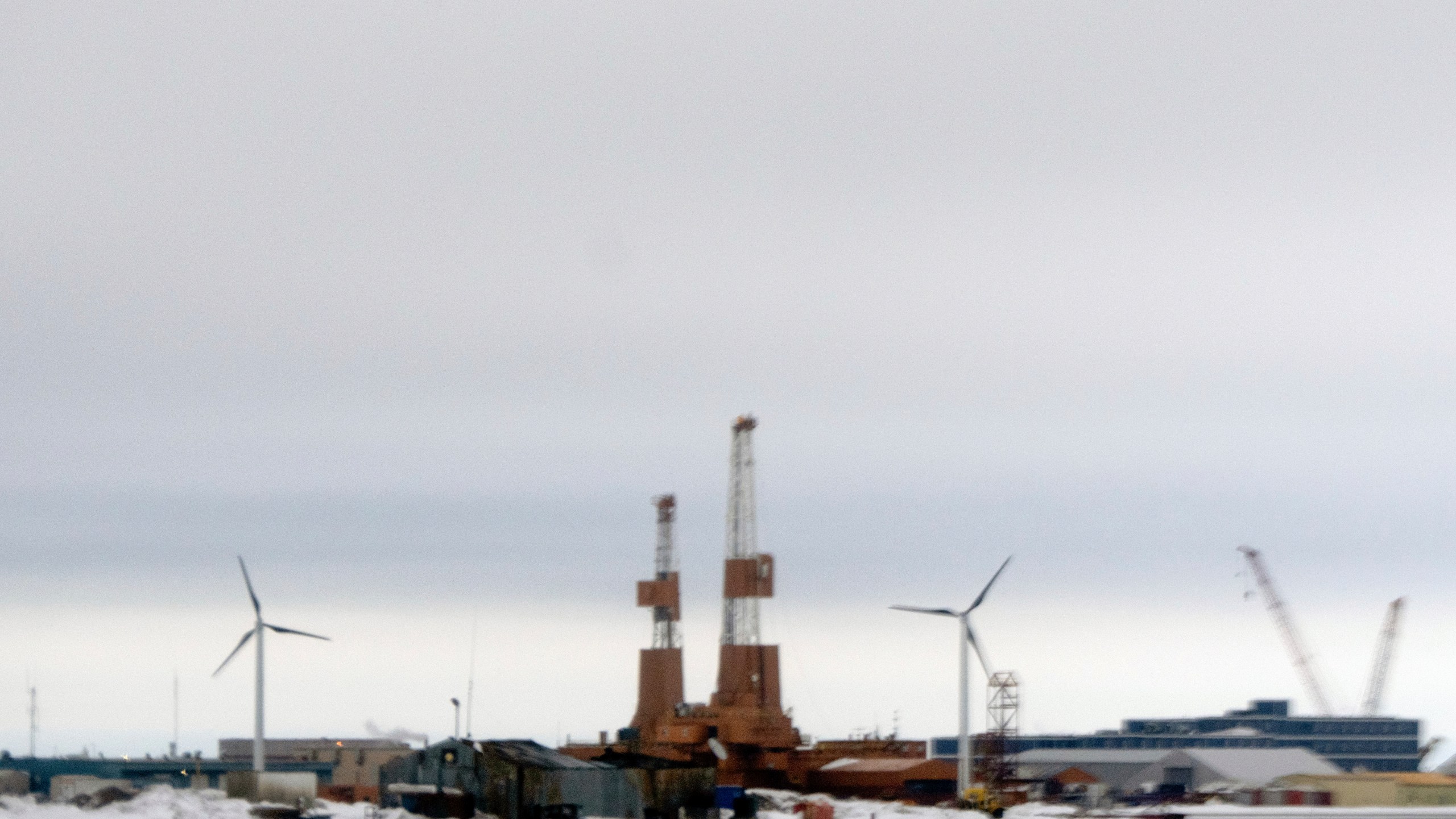 This image taken through a window of a plane shows wind turbines in Deadhorse, Alaska on Monday, June 2, 2025. (AP Photo/Jenny Kane)