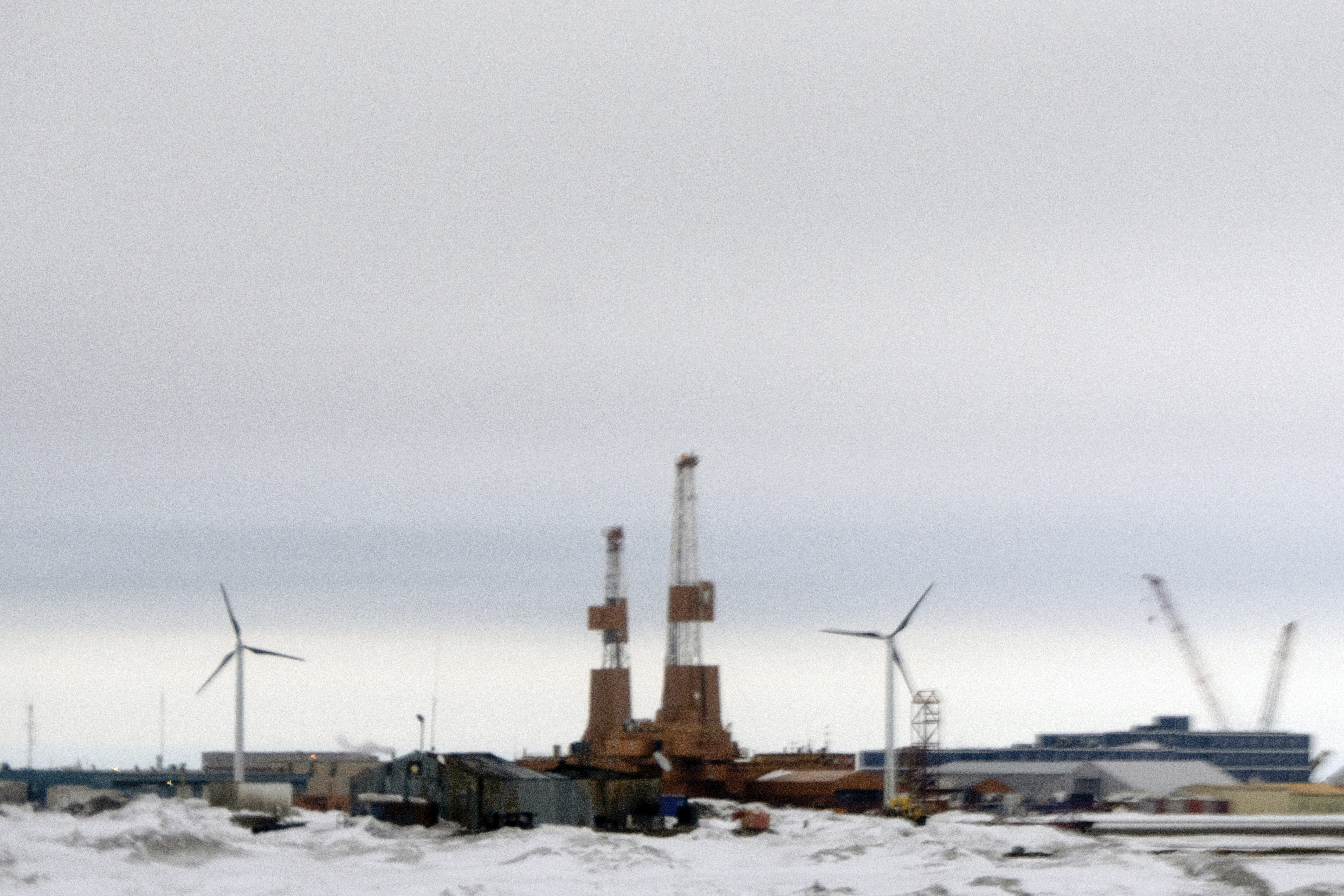 This image taken through a window of a plane shows wind turbines in Deadhorse, Alaska on Monday, June 2, 2025. (AP Photo/Jenny Kane)