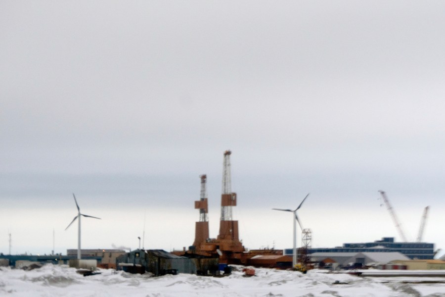 This image taken through a window of a plane shows wind turbines in Deadhorse, Alaska on Monday, June 2, 2025. (AP Photo/Jenny Kane)