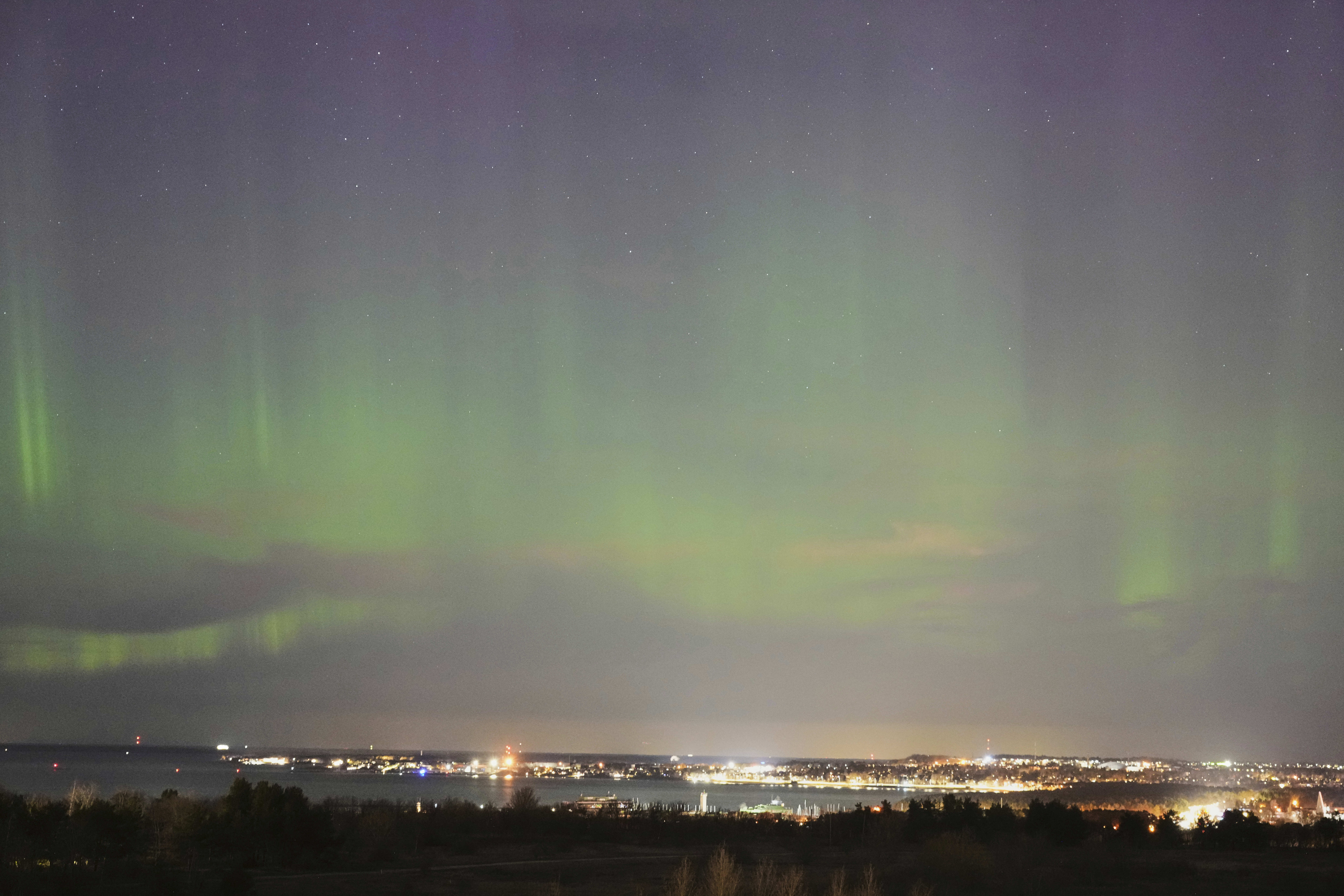 FILE - An aurora borealis, also known as the northern lights, is seen in the night sky over the Tallinn bay of the Baltic sea in Tallinn, Estonia, April 2, 2025. (AP Photo/Sergei Grits, file)