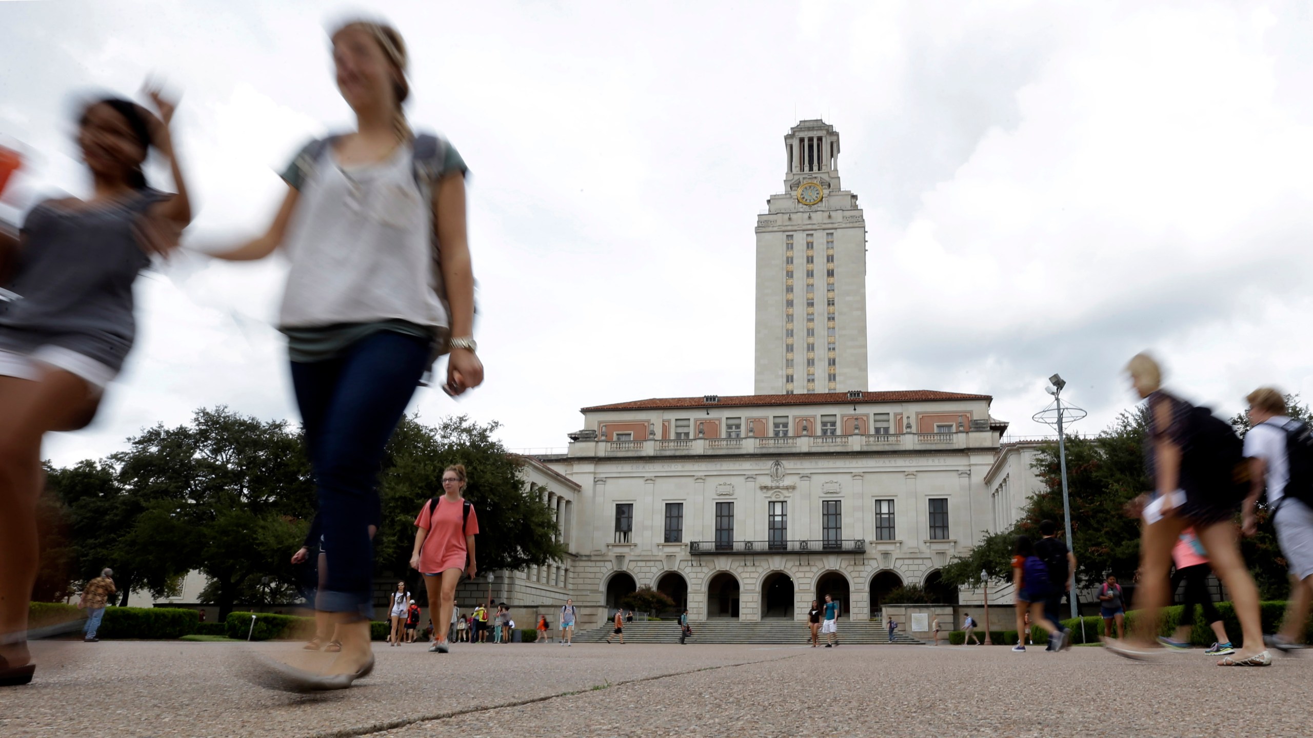FILE - In this Sept. 27, 2012, file photo, students walk through the University of Texas at Austin campus near the school's iconic tower in Austin, Texas. (AP Photo/Eric Gay, File)