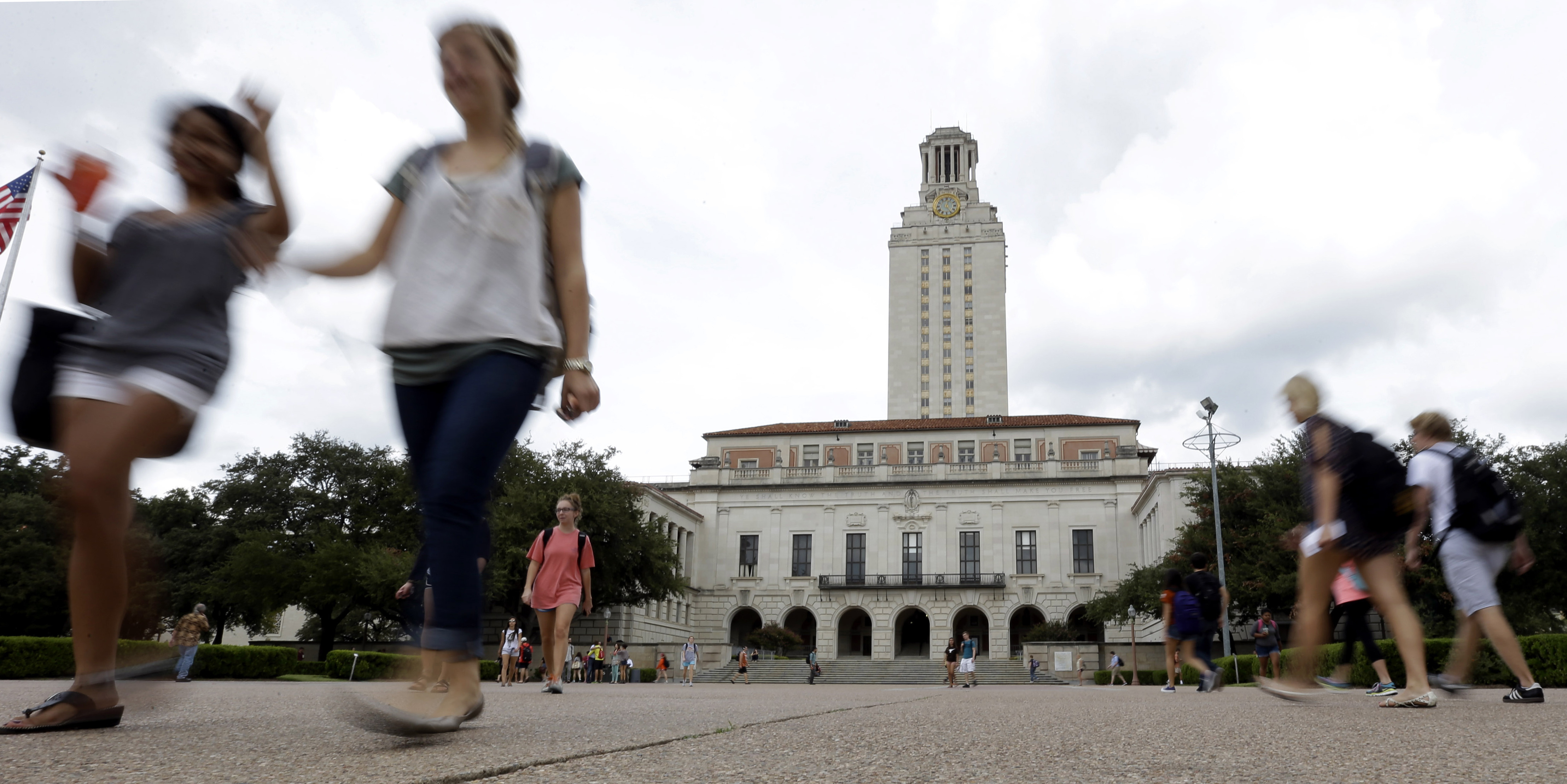 FILE - In this Sept. 27, 2012, file photo, students walk through the University of Texas at Austin campus near the school's iconic tower in Austin, Texas. (AP Photo/Eric Gay, File)