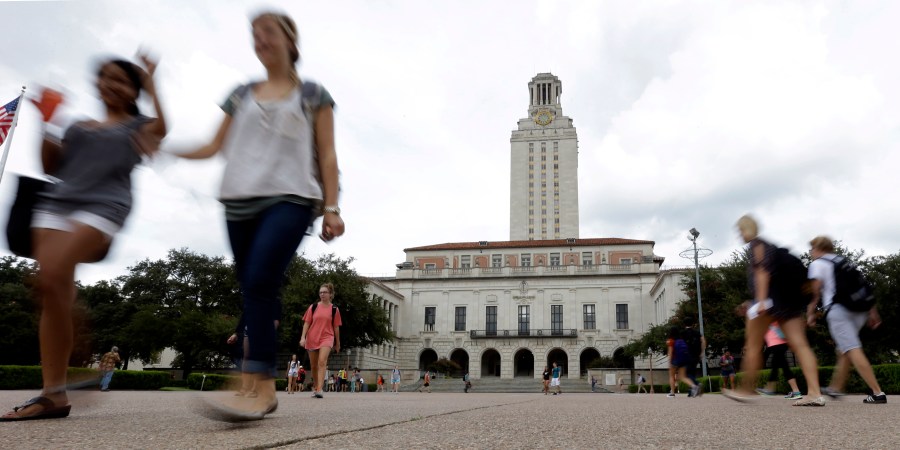 FILE - In this Sept. 27, 2012, file photo, students walk through the University of Texas at Austin campus near the school's iconic tower in Austin, Texas. (AP Photo/Eric Gay, File)