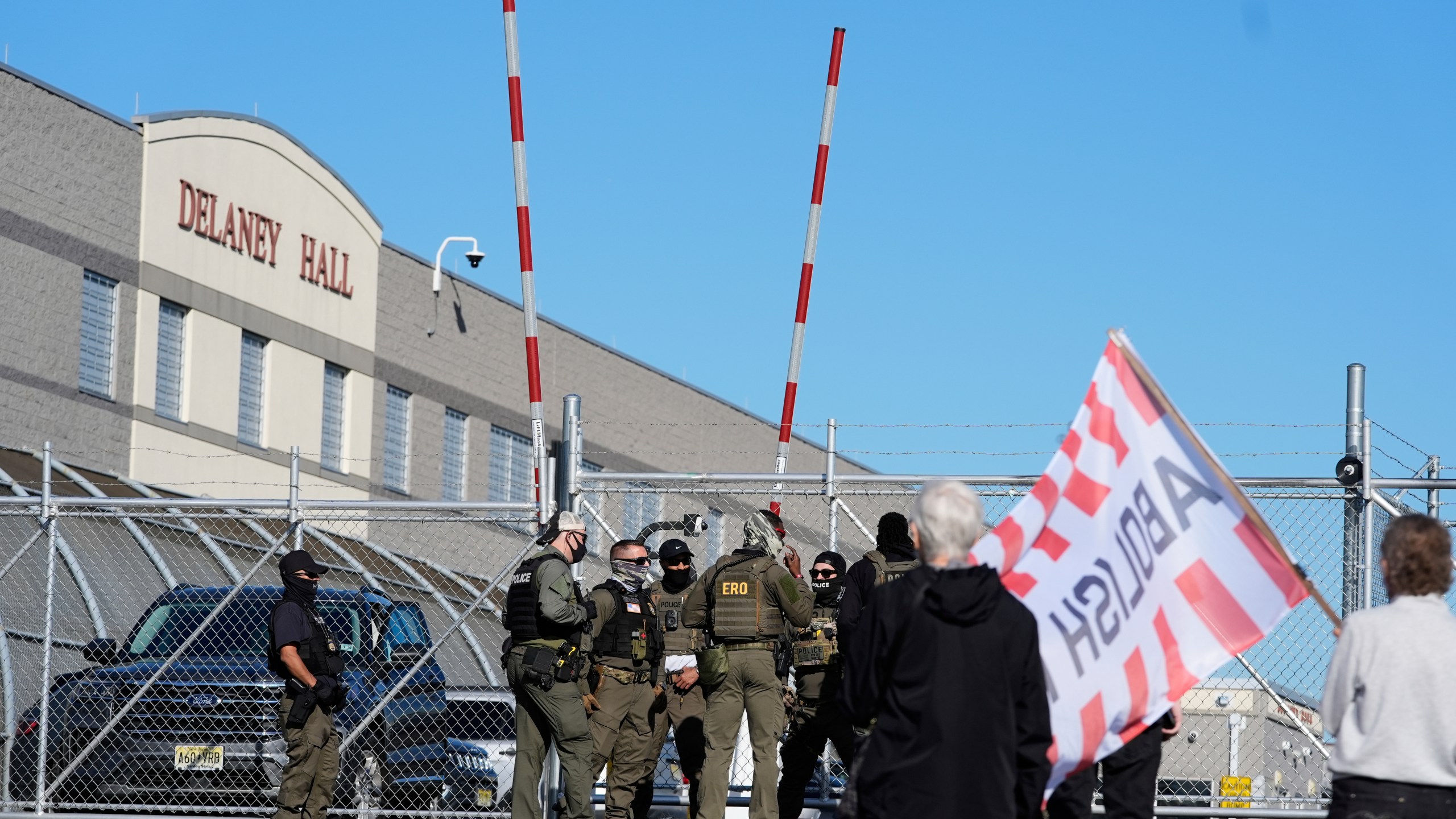 Protesters and security stand in front of Delaney Hall, a recently re-opened immigration detention center, in Newark, N.J., Wednesday, May 7, 2025. (AP Photo/Seth Wenig)