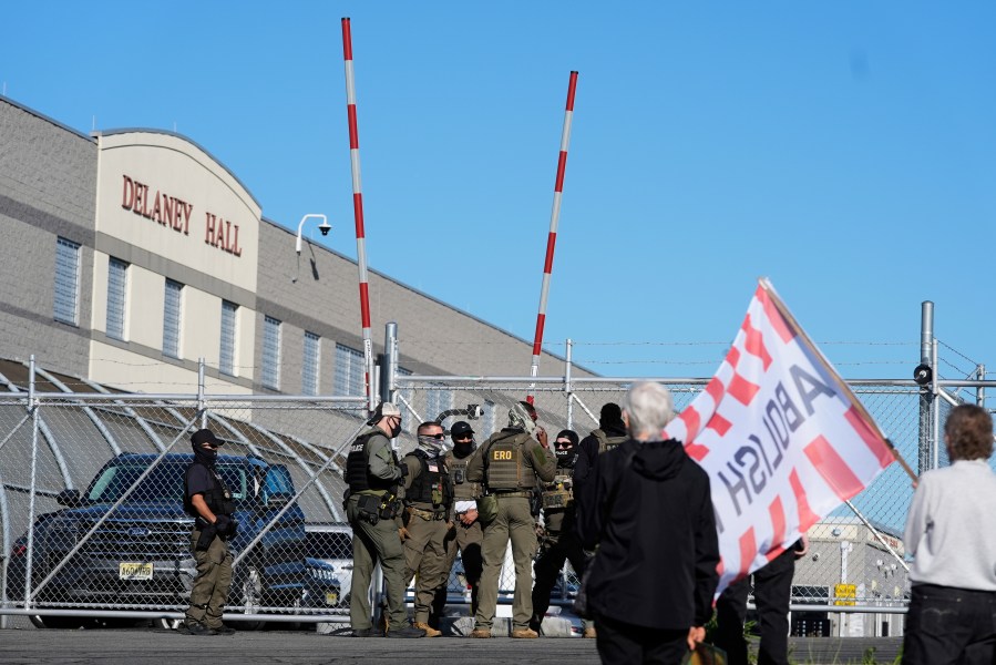 Protesters and security stand in front of Delaney Hall, a recently re-opened immigration detention center, in Newark, N.J., Wednesday, May 7, 2025. (AP Photo/Seth Wenig)