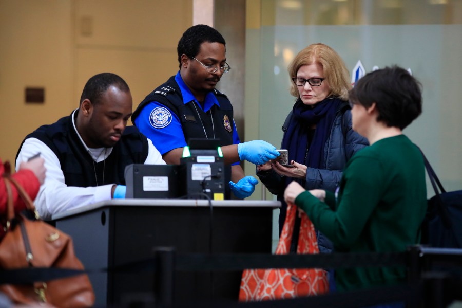 FILE - Transportation Security Administration workers screen airline passengers at Reagan Washington National Airport in Washington, Monday, Jan. 28, 2019. (AP Photo/Manuel Balce Ceneta,File)