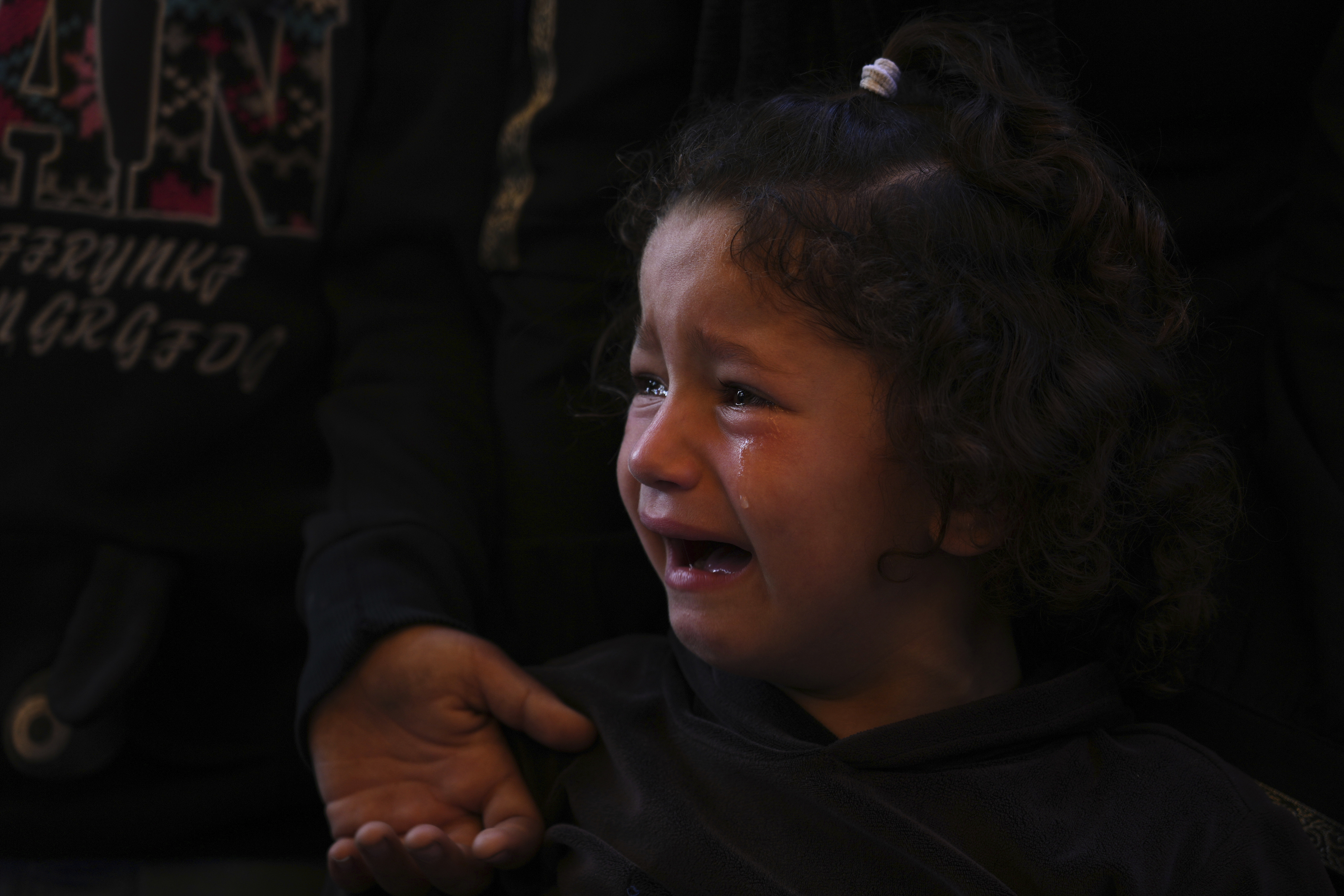 Mira, 4, cries during the funeral of her father, Hosam Wafi who, according to family members, was killed during an Israeli strike, in Khan Younis, southern Gaza Strip, Monday, June 2, 2025. (AP Photo/Abdel Kareem Hana)