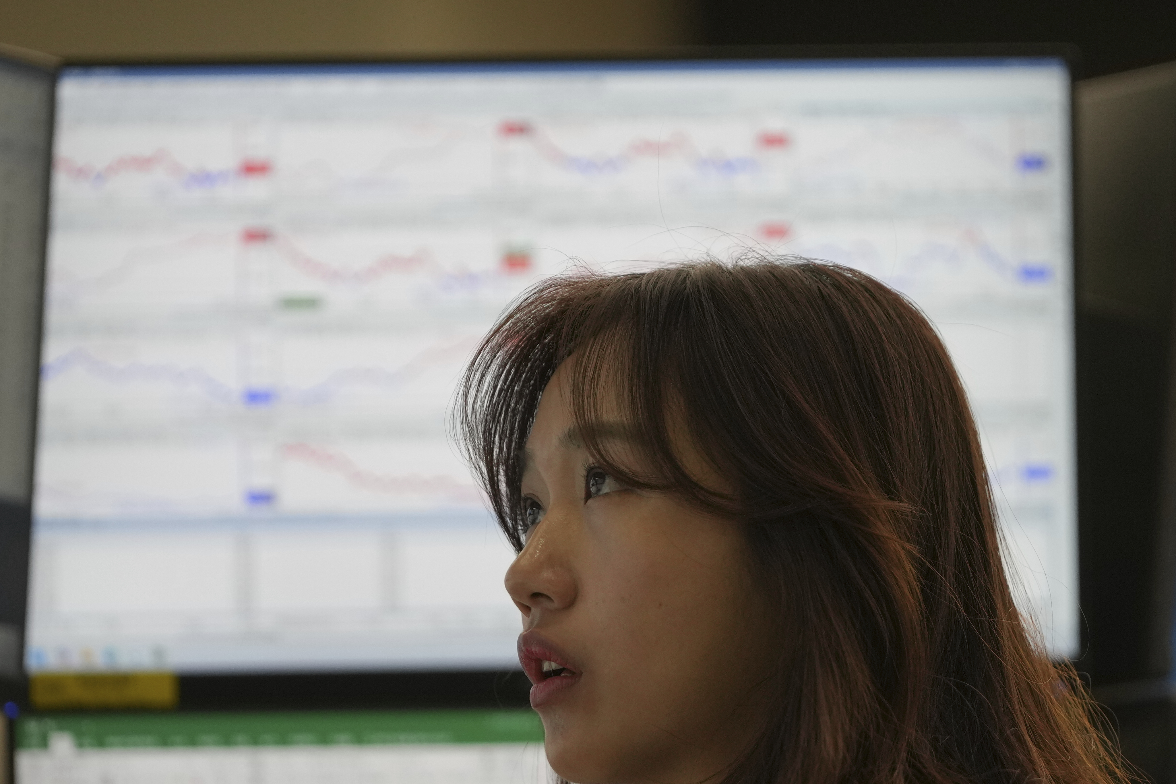 A dealer watches computer monitors at a dealing room of Hana Bank in Seoul, South Korea, Monday, June 2, 2025. (AP Photo/Lee Jin-man)