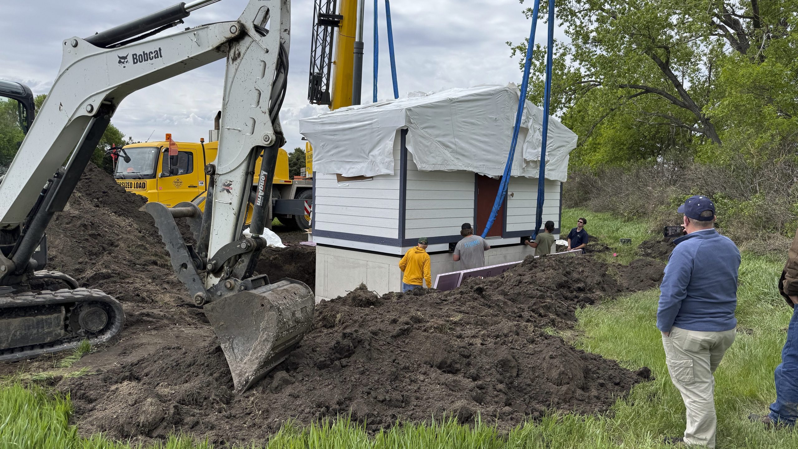 Workers install a restroom at the Welk Homestead State Historic Site near Strasburg, North Dakota, on Friday, May 23, 2025. (Photo by Rob Hanna via AP)