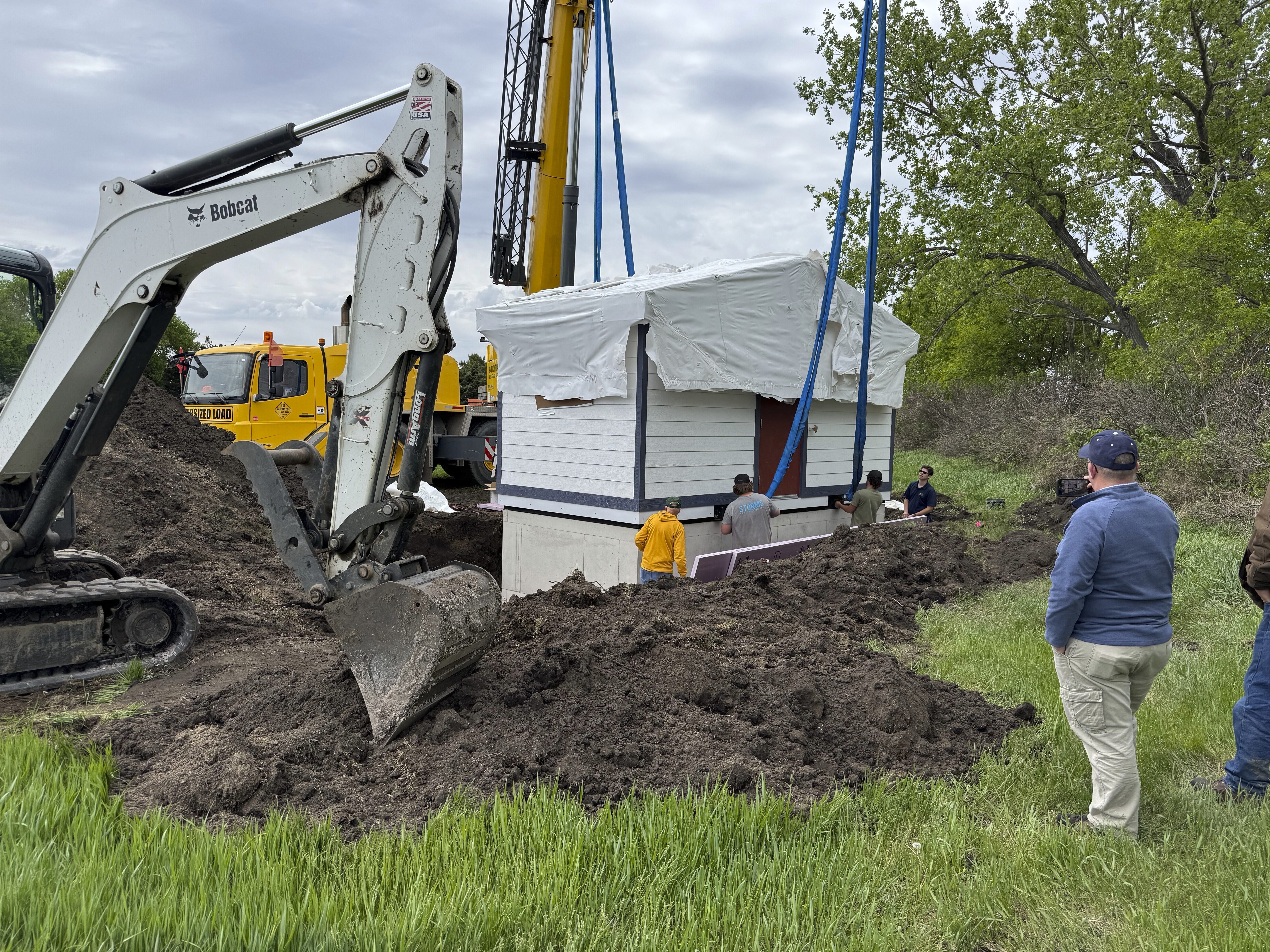 Workers install a restroom at the Welk Homestead State Historic Site near Strasburg, North Dakota, on Friday, May 23, 2025. (Photo by Rob Hanna via AP)
