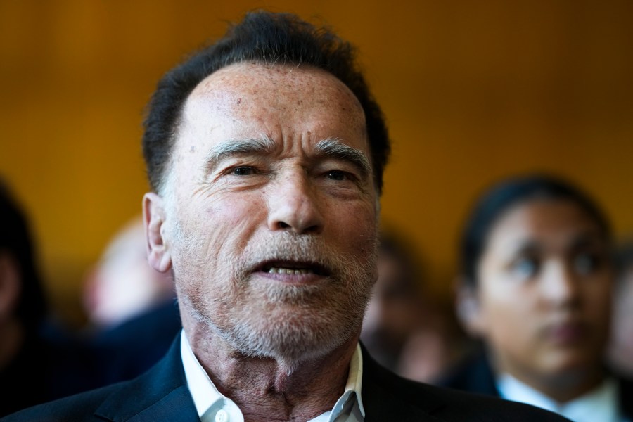 FILE - Former California Gov. and actor Arnold Schwarzenegger, center, arrives for a ceremony to receive a honorary doctorate by the Hertie School, a university of governance, in Berlin, Germany, Tuesday, Sept. 17, 2024. (AP Photo/Markus Schreiber, File)