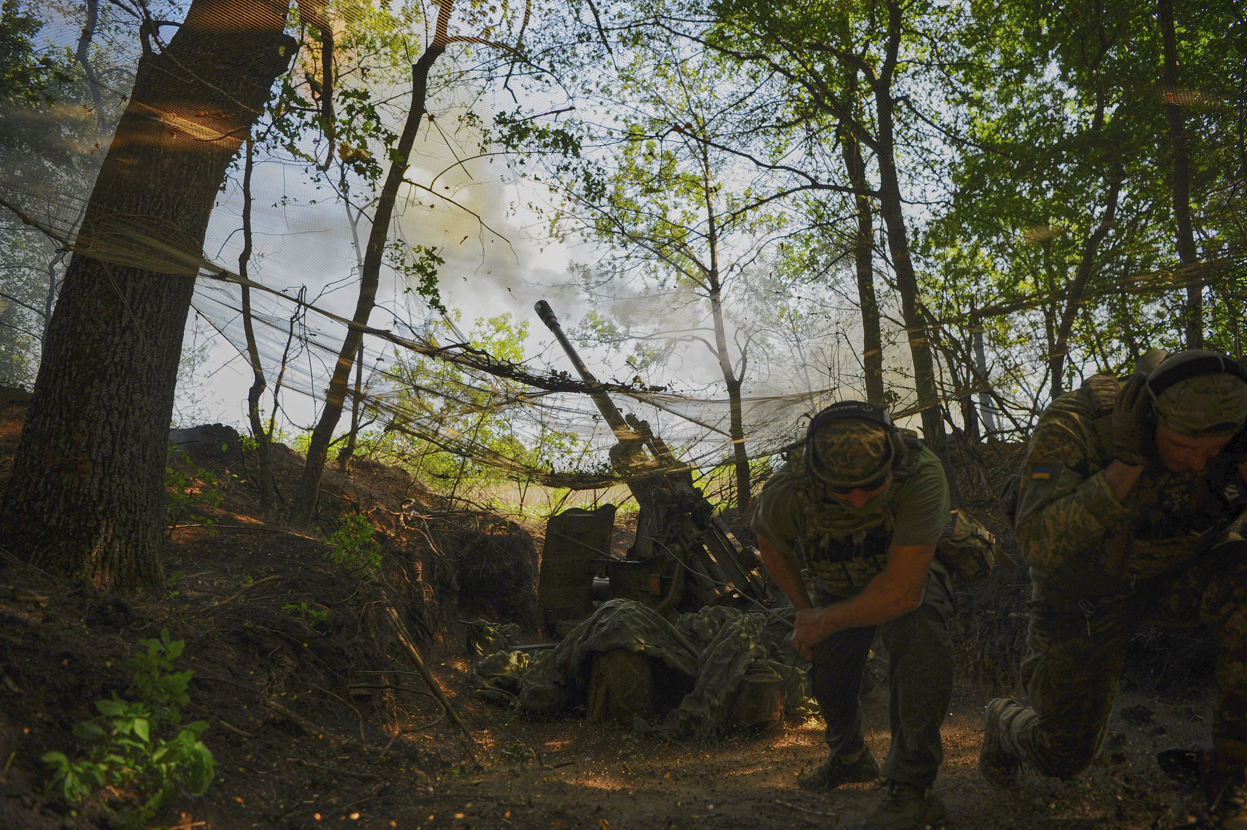 In this photo provided by Ukraine's 127th Separate Brigade of the Territorial Defence press service, soldiers fire a canon towards Russian army positions near Kharkiv, Ukraine, Monday, June 2, 2025, (Anatolii Lysianskyi/Ukraine's 127th Separate Brigade via AP)
