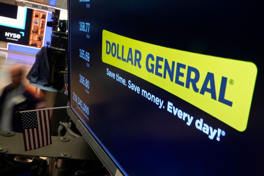 FILE - The logo for Dollar General appears on a screen above a trading post on the floor of the New York Stock Exchange, July 13, 2023. (AP Photo/Richard Drew, File)