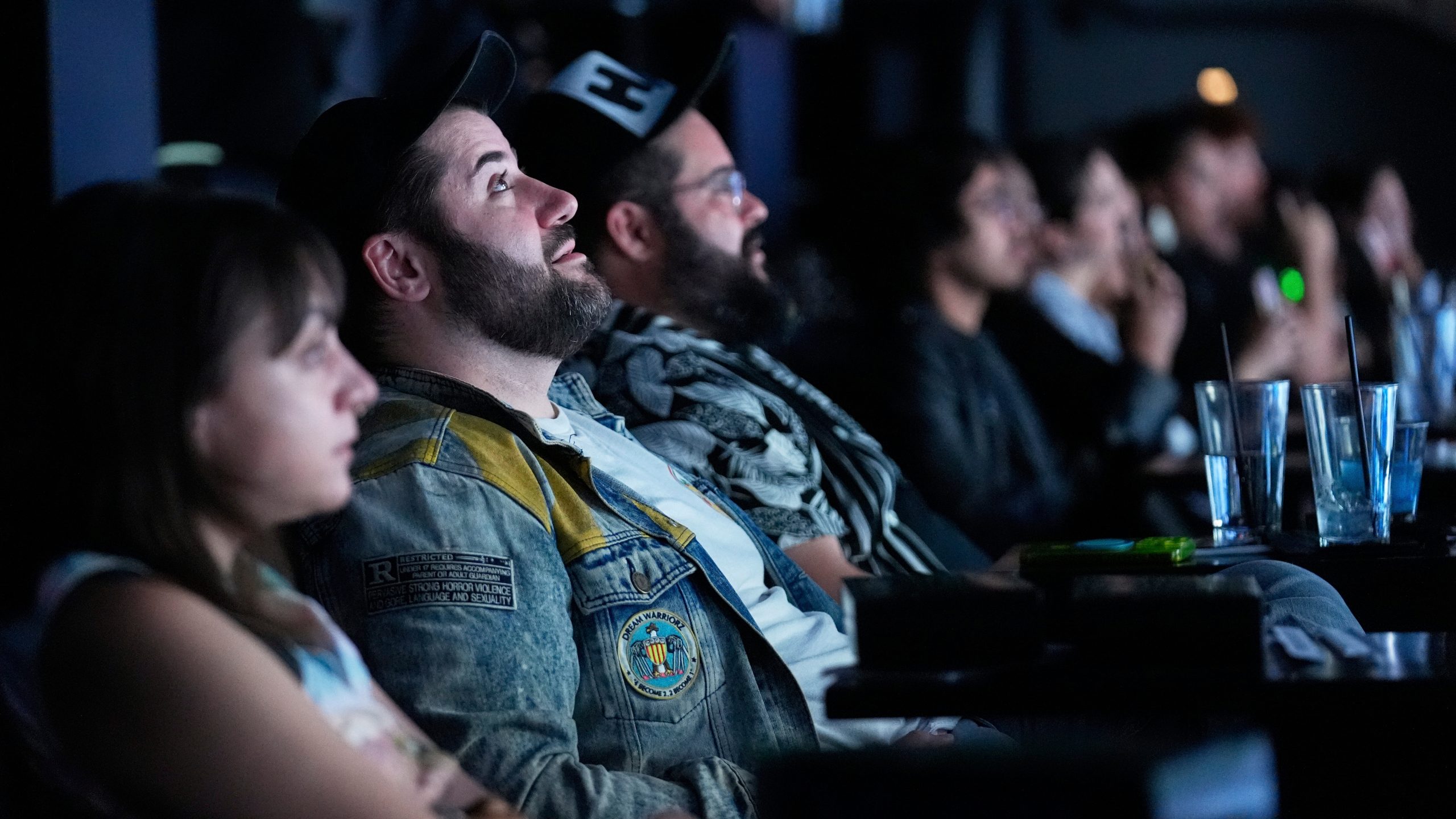 Audience member Matt Raub, second from left, watches immersive visuals above the movie screen during a screening of "The Matrix in Shared Reality" on Wednesday, May 28, 2025, at Cosm Los Angeles in Inglewood, Calif. (AP Photo/Chris Pizzello)