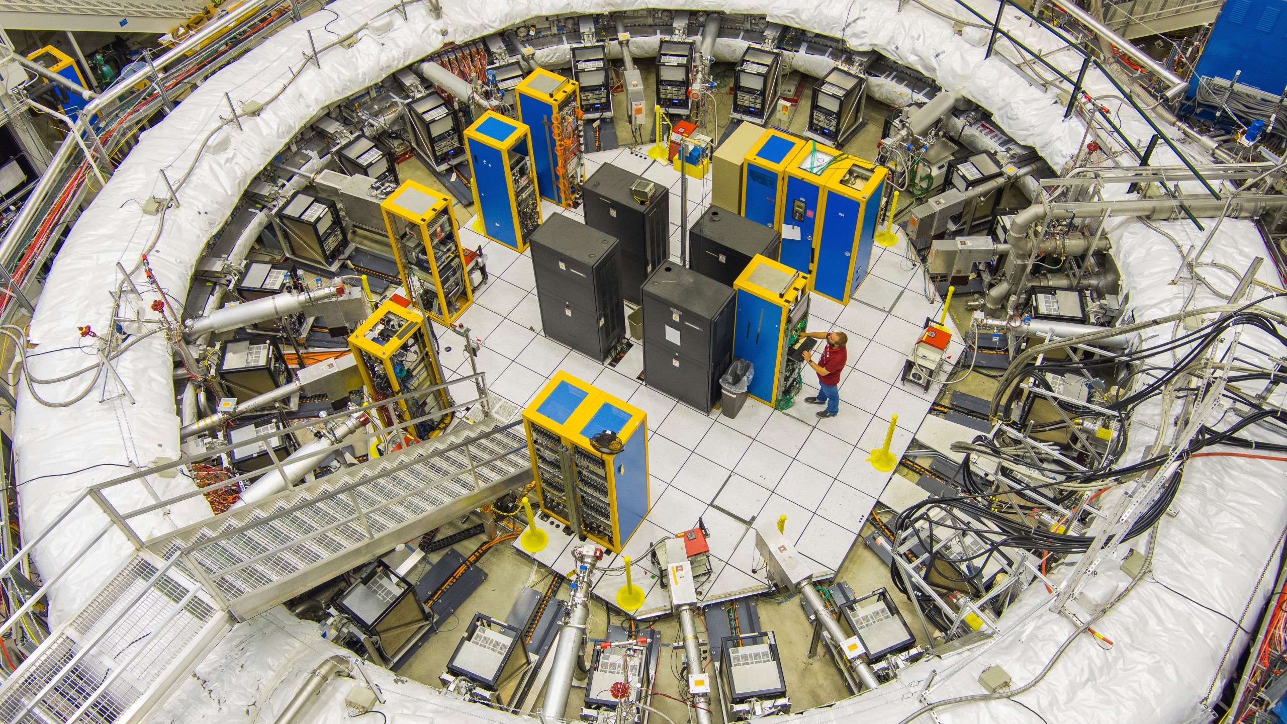 This image provided by the Fermi National Accelerator Laboratory shows the ring-shaped track that scientists used to study tiny particles called muons, July 20, 2023 in Batavia, Ill. (Ryan Posteland/Fermi National Accelerator Laboratory via AP)