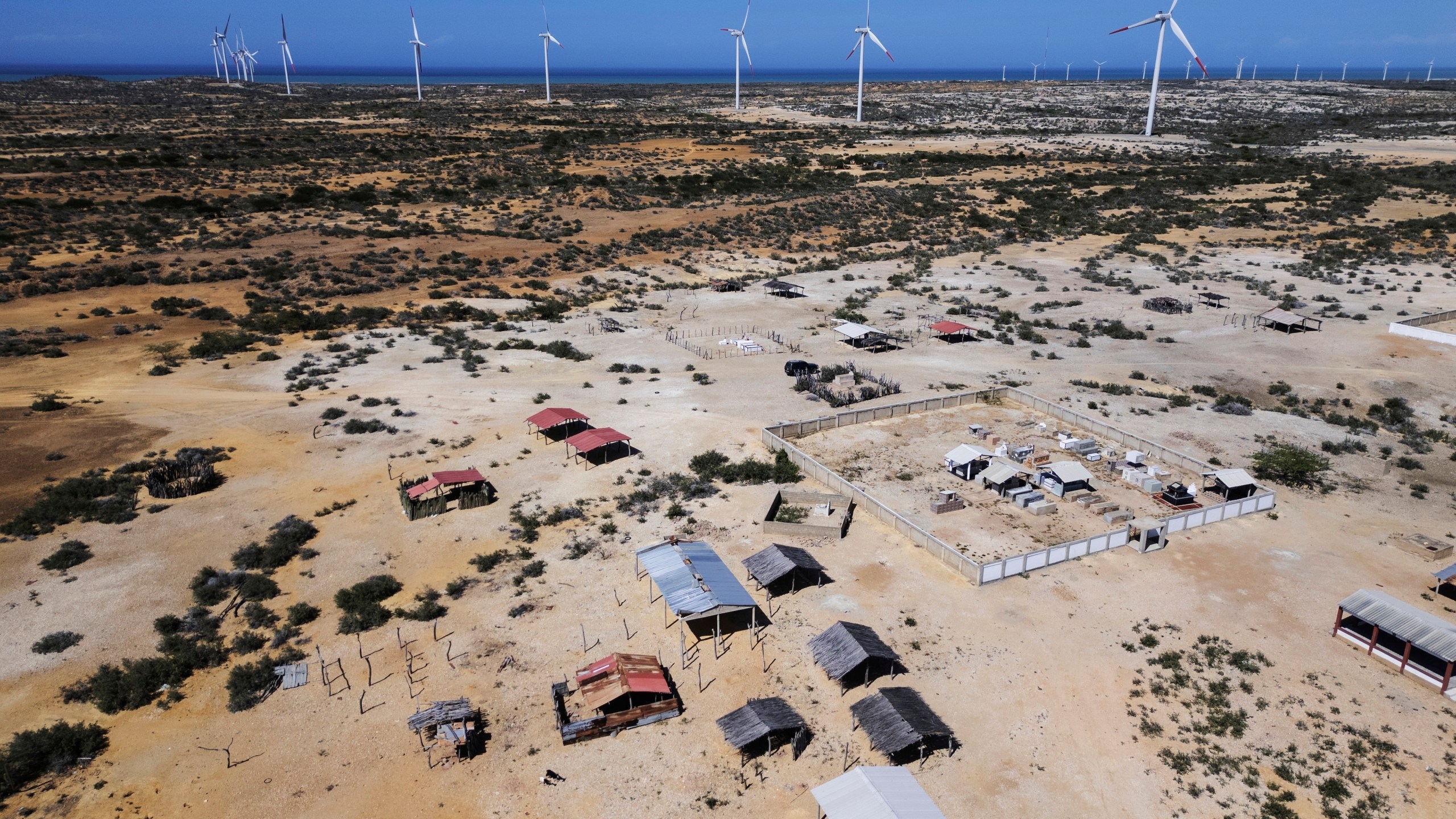 FILE - Wind turbines operate near a Wayuu Indigenous cemetery on the outskirts of Cabo de la Vela, Colombia, Feb. 7, 2025. (AP Photo/Ivan Valencia, File)