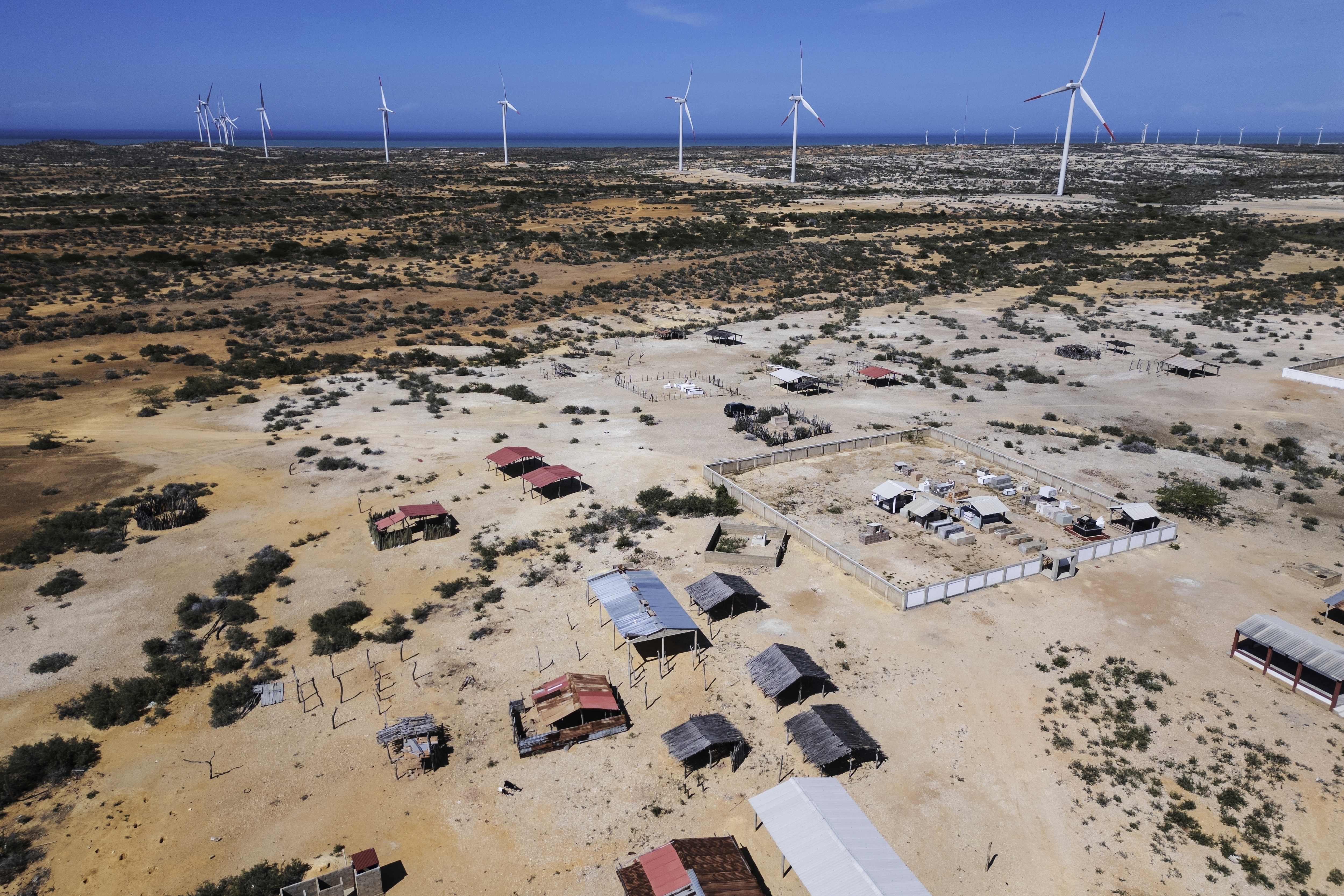 FILE - Wind turbines operate near a Wayuu Indigenous cemetery on the outskirts of Cabo de la Vela, Colombia, Feb. 7, 2025. (AP Photo/Ivan Valencia, File)