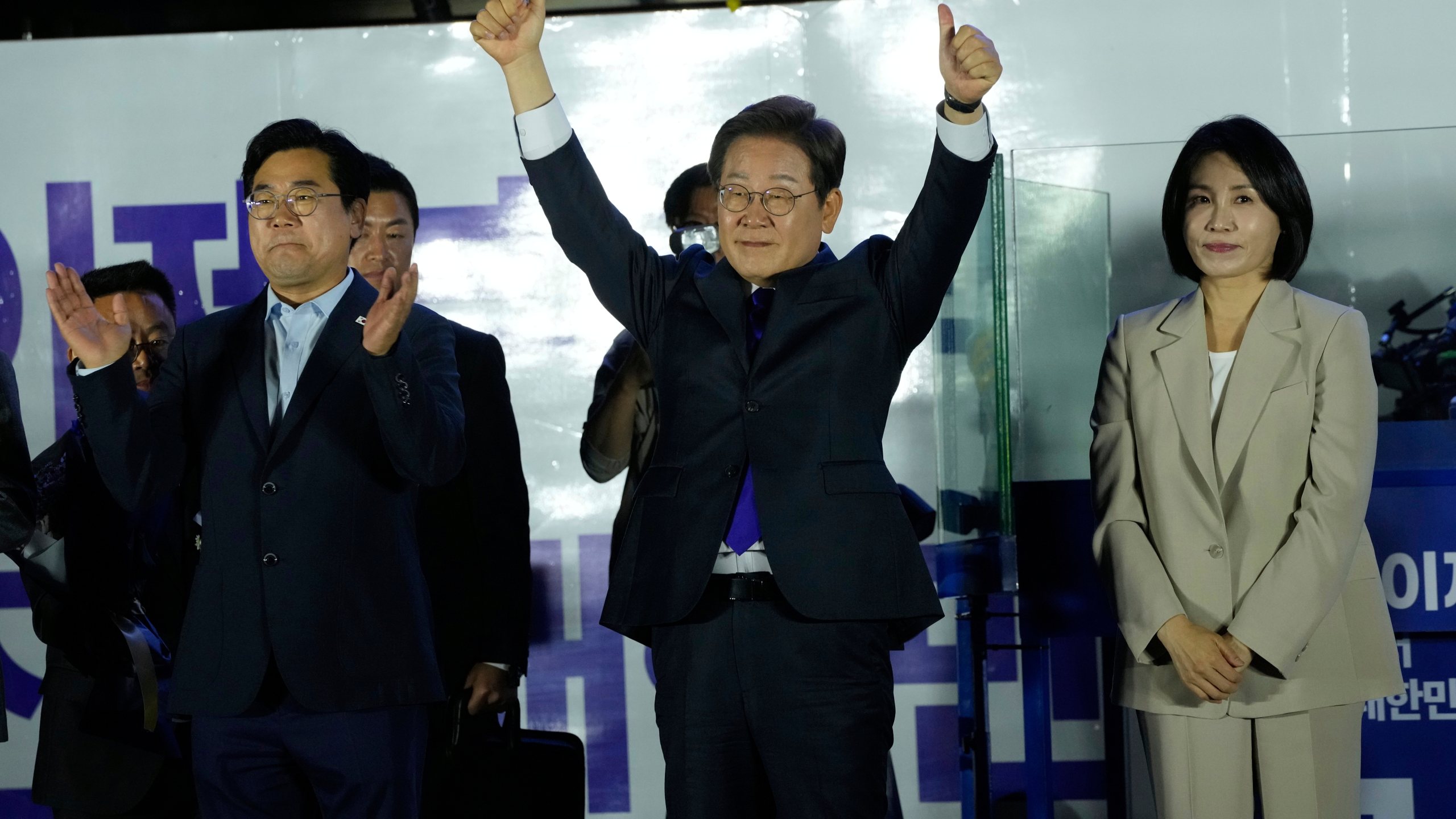 South Korea's Democratic Party's presidential candidate Lee Jae-myung, center, and his wife Kim Hea Kyung, right, greet supporters outside of the National Assembly in Seoul, South Korea, Wednesday, June 4, 2025. (AP Photo/Ahn Young-joon)