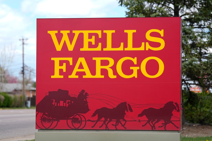 FILE - A sign stands outside a branch of Wells Fargo bank Wednesday, April 17, 2024, in Littleton, Colo. (AP Photo/David Zalubowski, File)