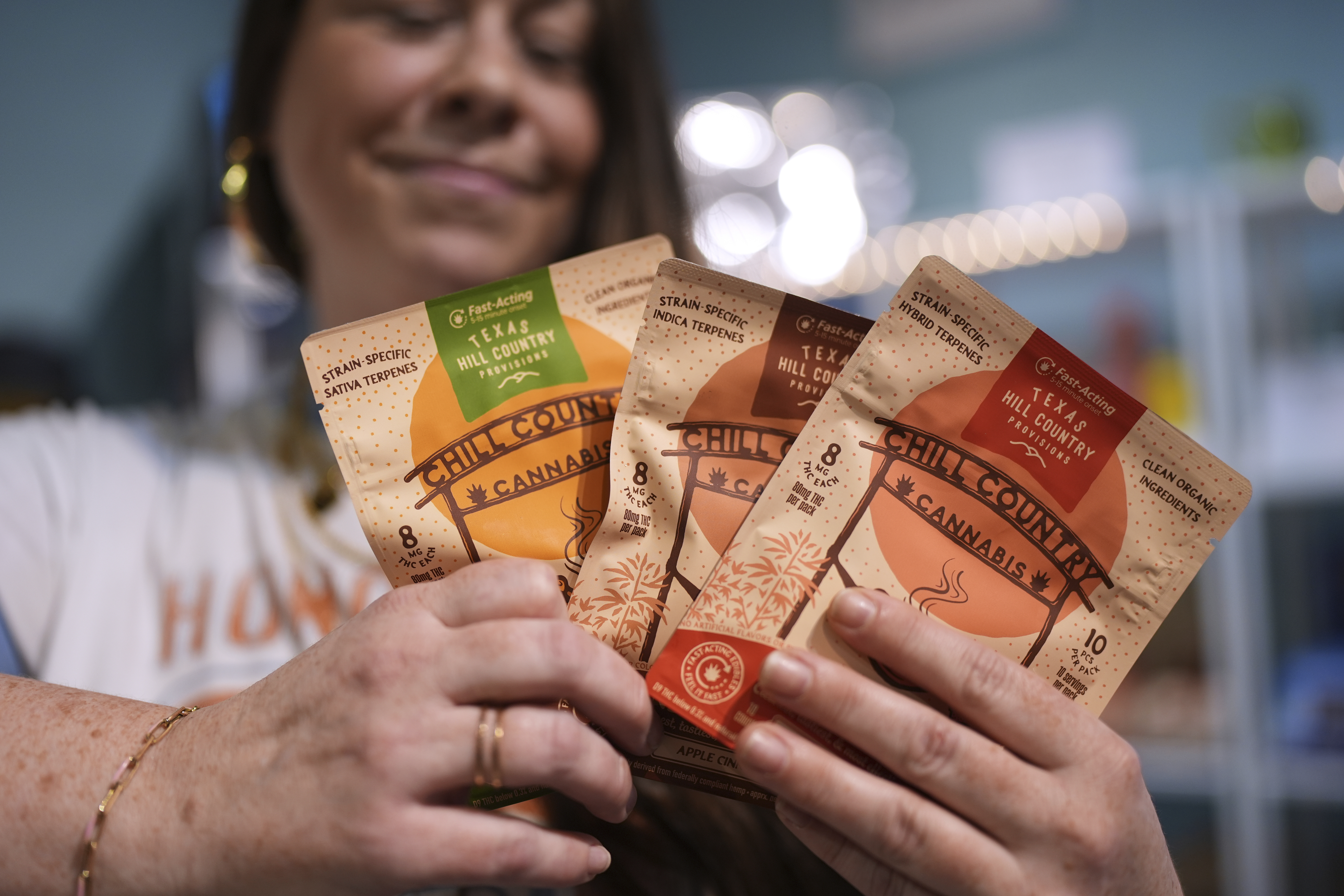 Employee Savannah Gavlik displays THC products at the Dope Daughters dispensary that Texas lawmakers are seeking to ban, Thursday, May 29, 2025, in Austin, Texas. (AP Photo/Eric Gay)